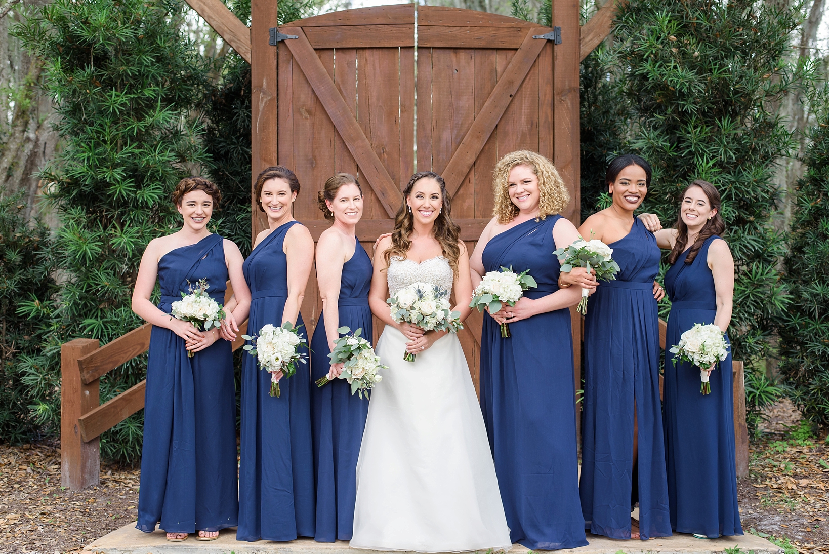 The Bride and her Bridesmaids in front of a large wooden door