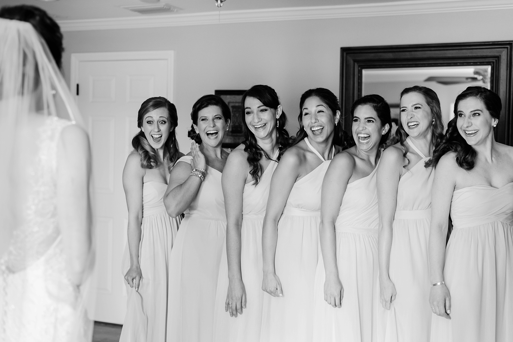 The bridesmaids seeing the bride for the first time on her wedding day by Sarah & Ben Photography