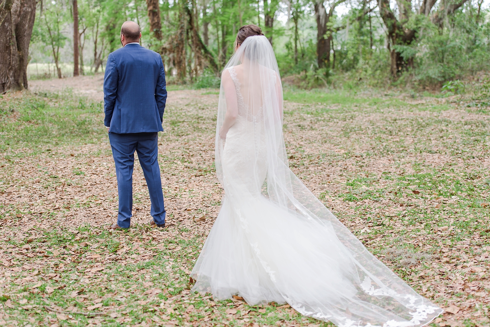 Bride walking up to her groom for their first look in a private rustic forest setting