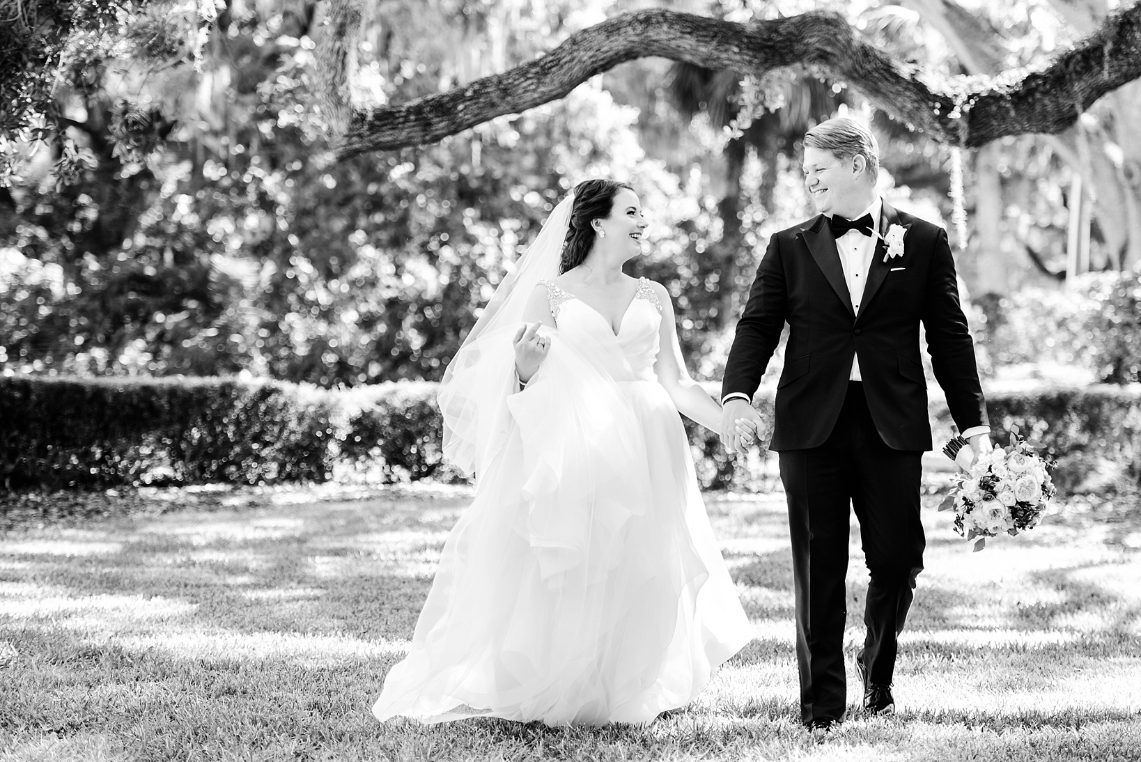Timeless image of a Bride and Groom laughing under the oak trees on their wedding day by Sarah & Ben Photography
