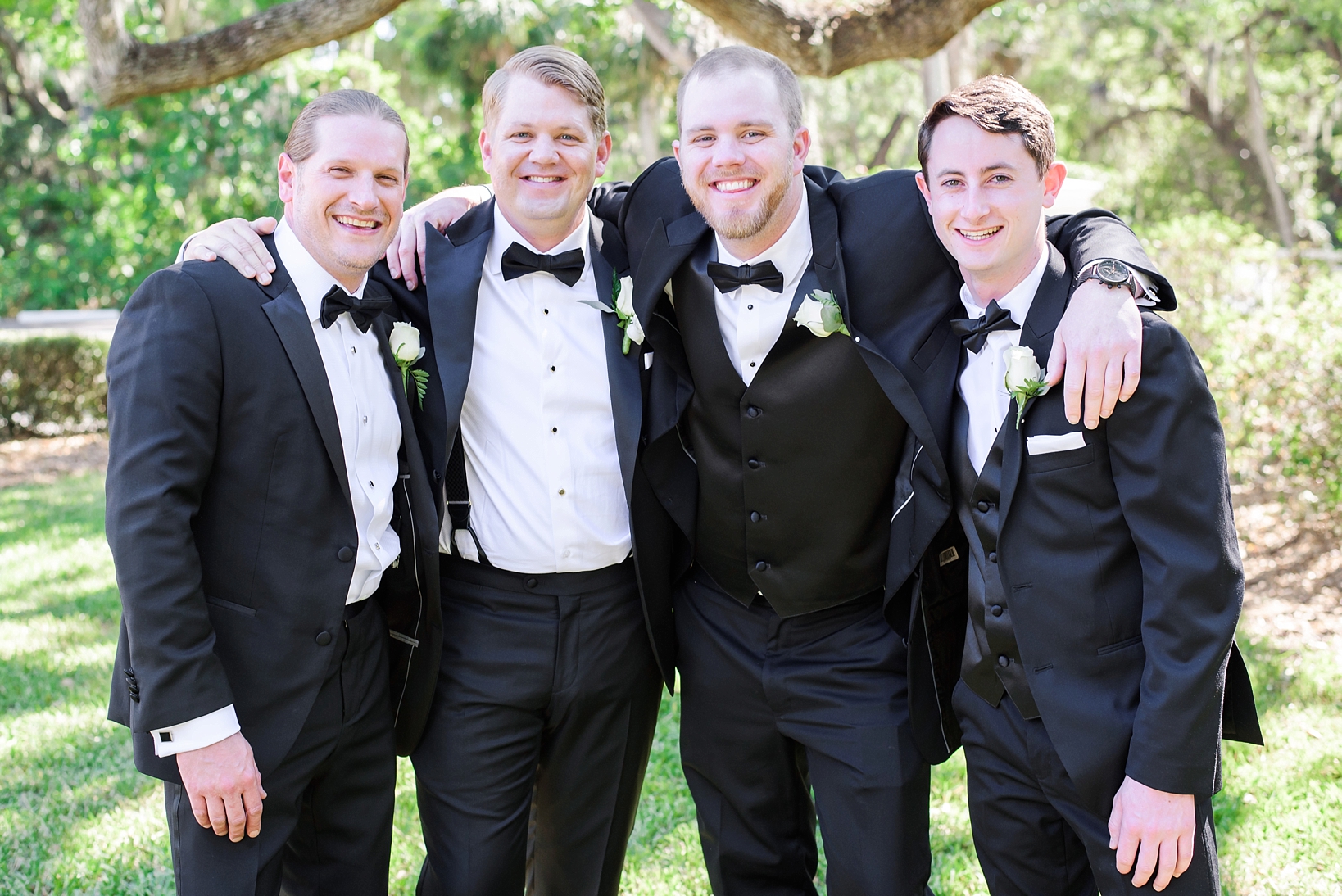 Groom and his groomsmen in a casual pose on the lawn of the tampa yacht club