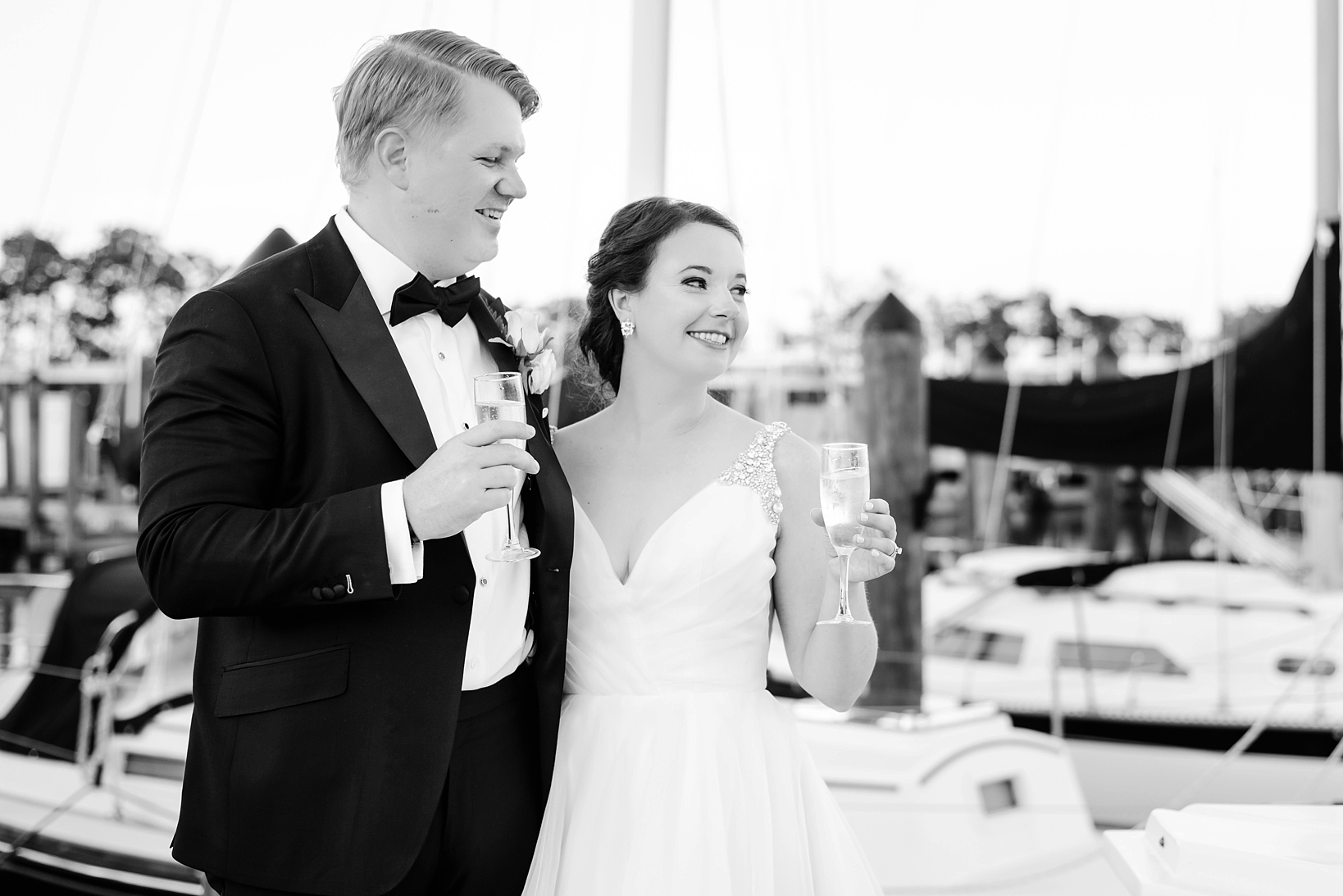 Champagne toasts during golden hour among the yachts by Sarah & Ben Photography