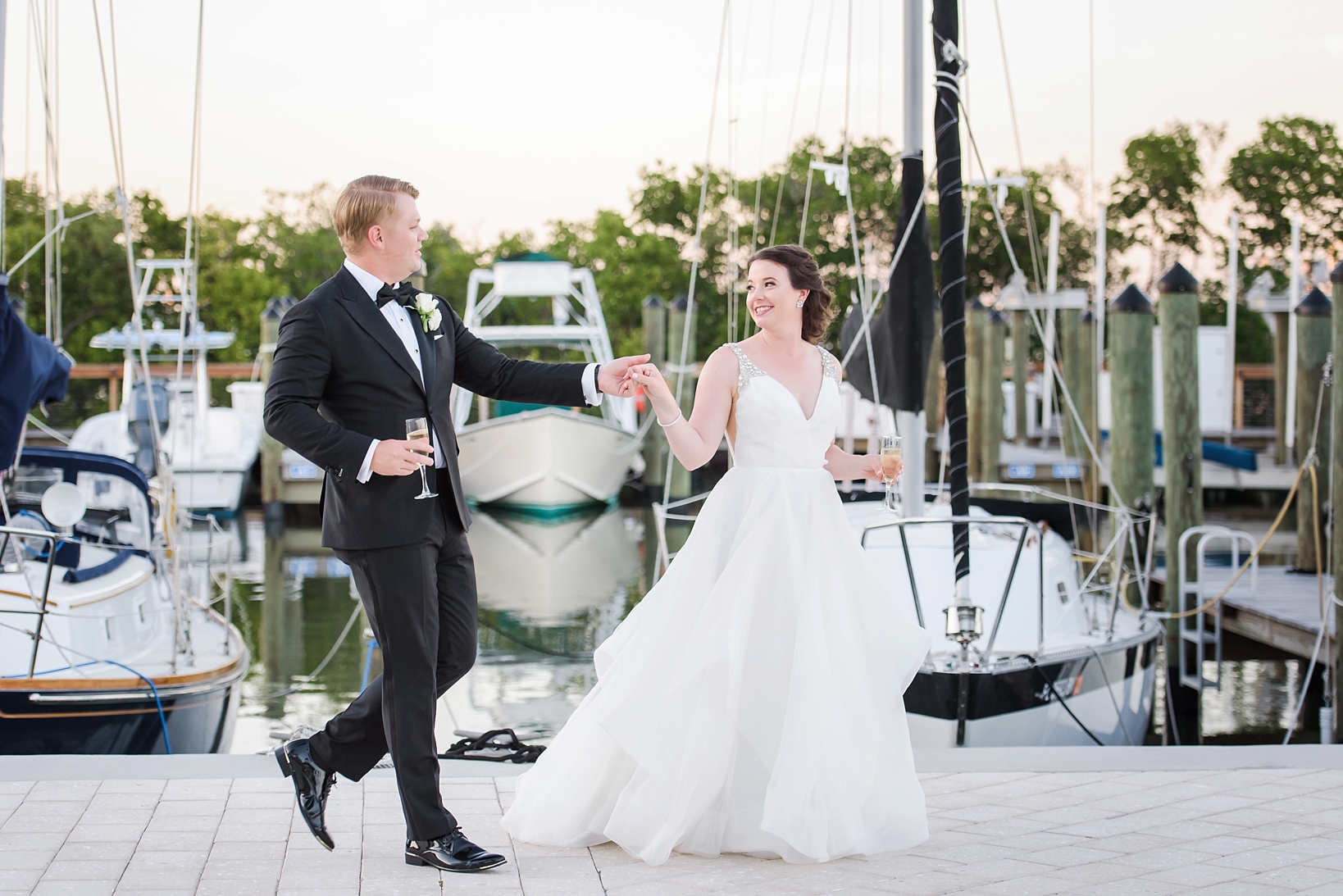 Bride and Groom sneak away for a champagne stroll on the docks by Sarah & Ben Photography