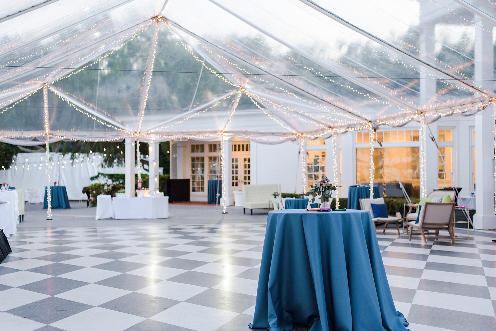 The clear tented reception space of the Tampa Yacht and Country Club with checkerboard flooring