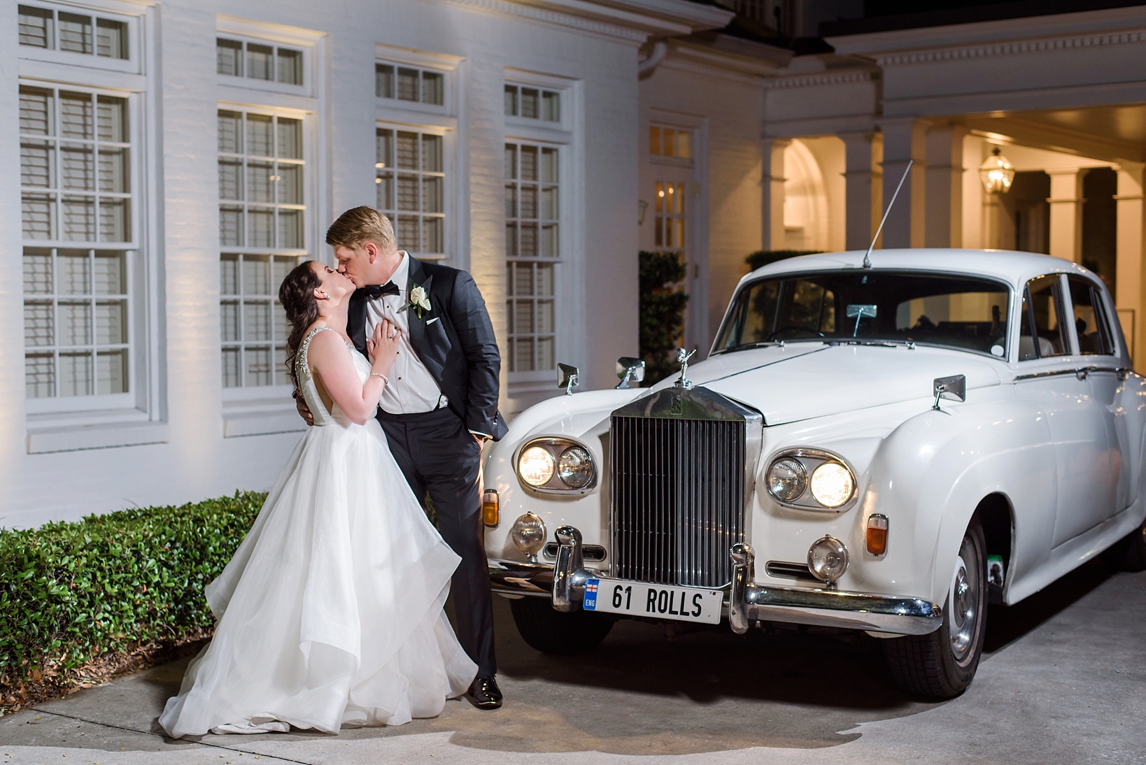1961 Rolls Royce and the Bride and Groom kissing by Sarah & Ben Photography