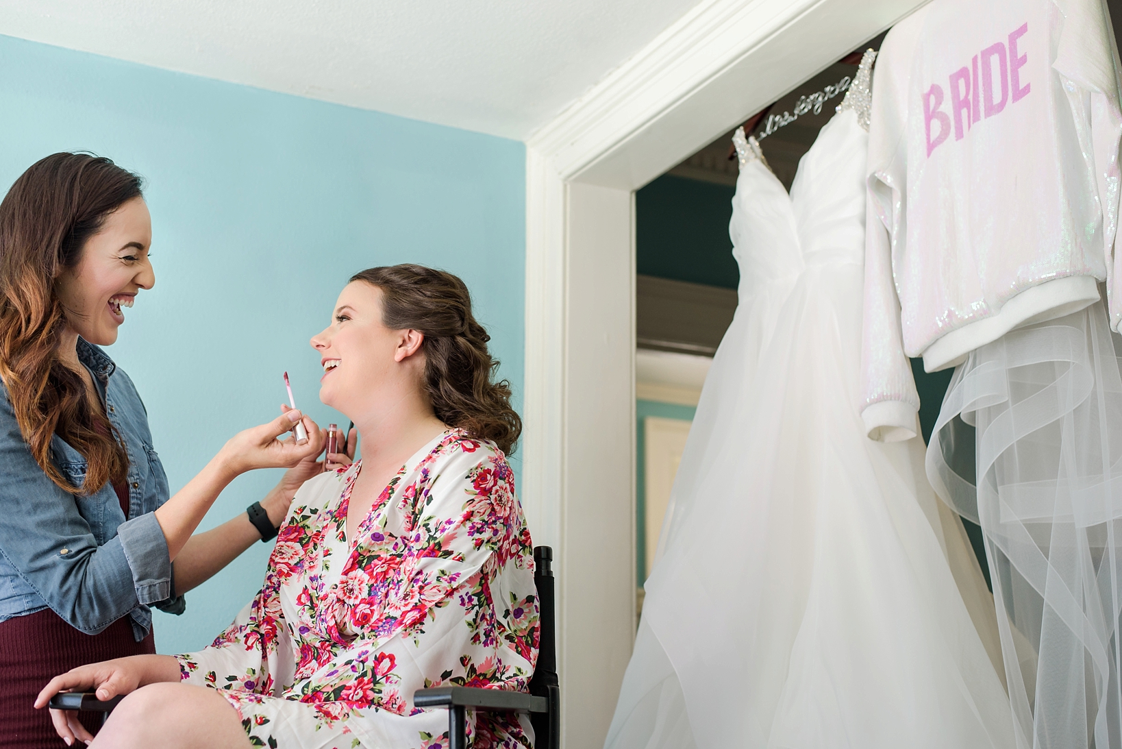 The bride getting her finishing touches of makeup done 