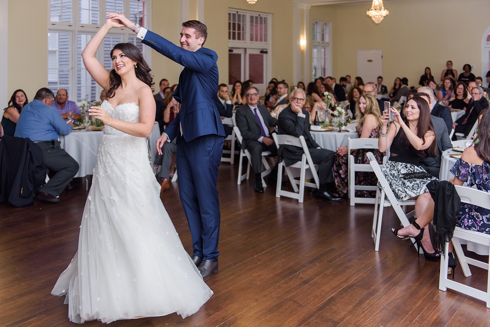 Bride being twirled by the Groom during their first dance by Sarah & Ben Photography