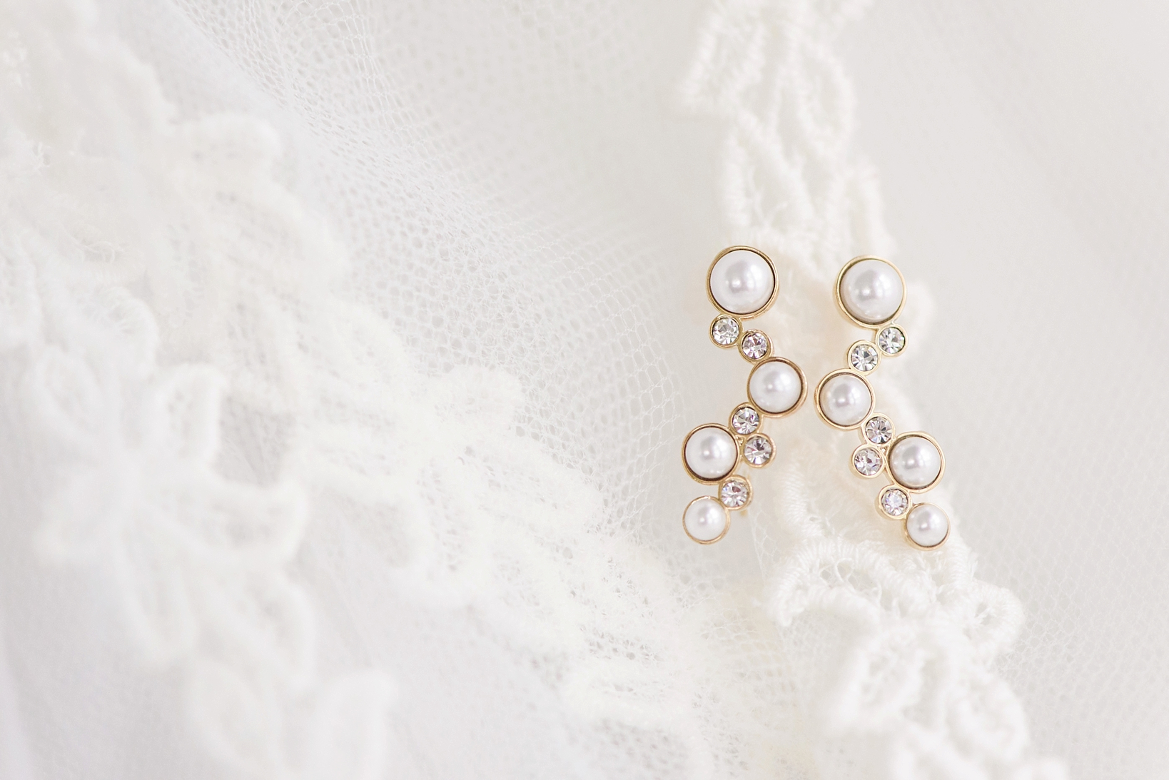 Pearl and Gold earrings against the lace details of the vintage bridal veil