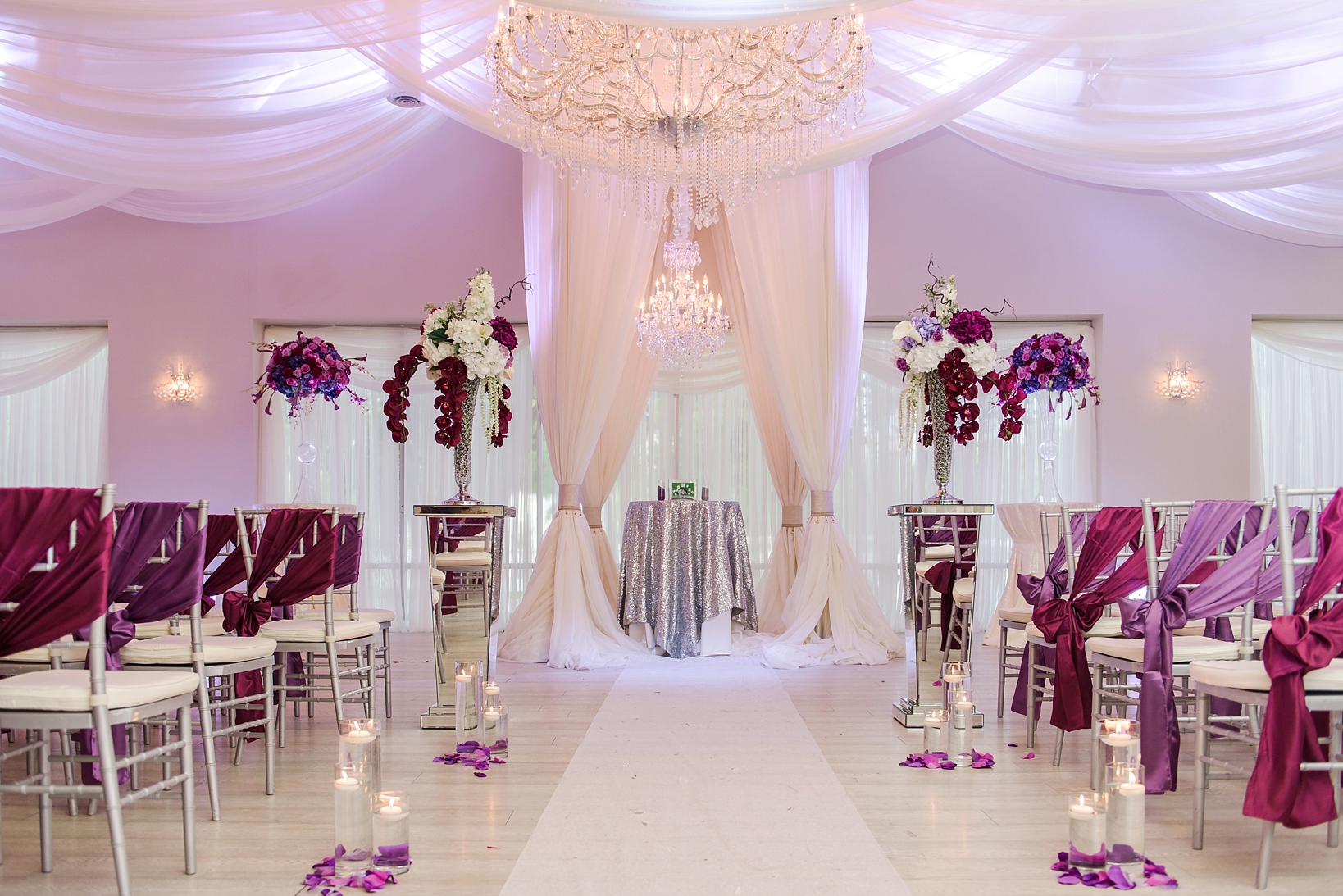 The ceremony space at the crystal ballroom in Clearwater, FL with pink uplights 