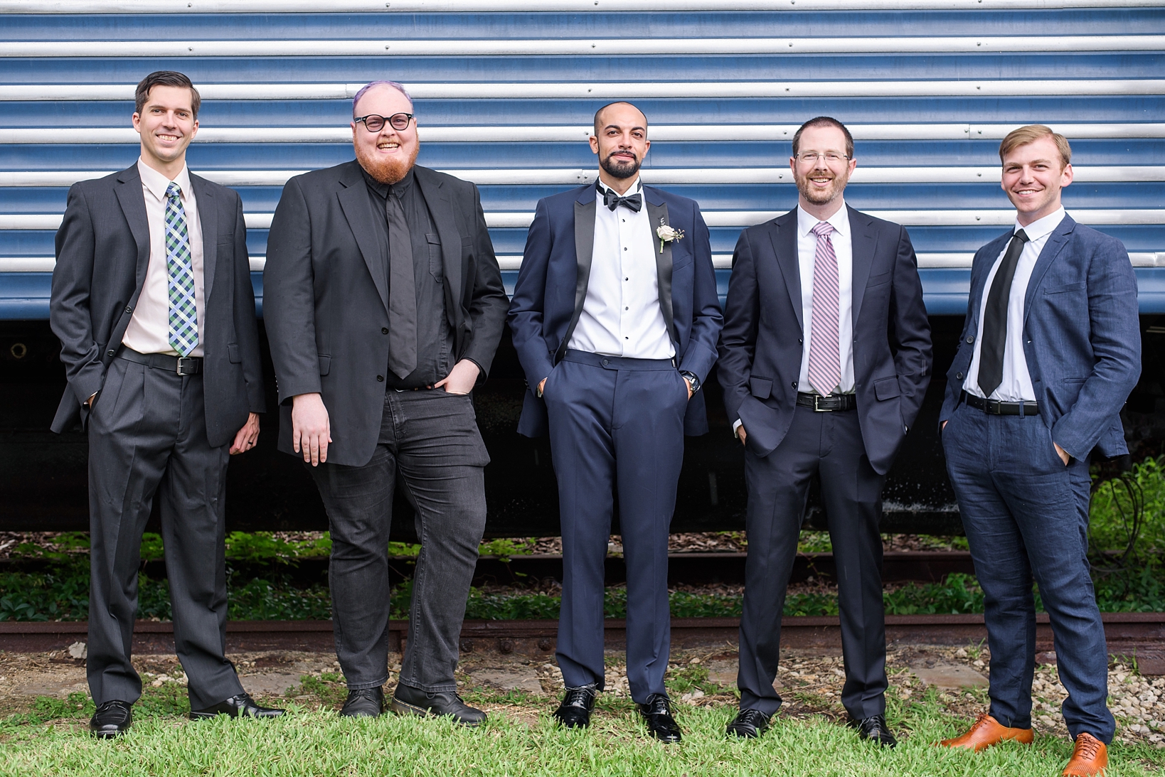 The groom with his groomsmen in mix matched suits by Sarah & Ben Photography