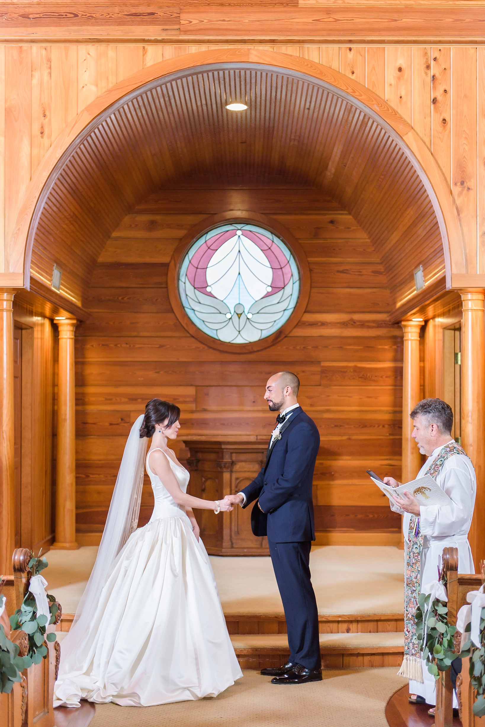 Bride and Groom up at the altar during their ceremony by Sarah & Ben Photography