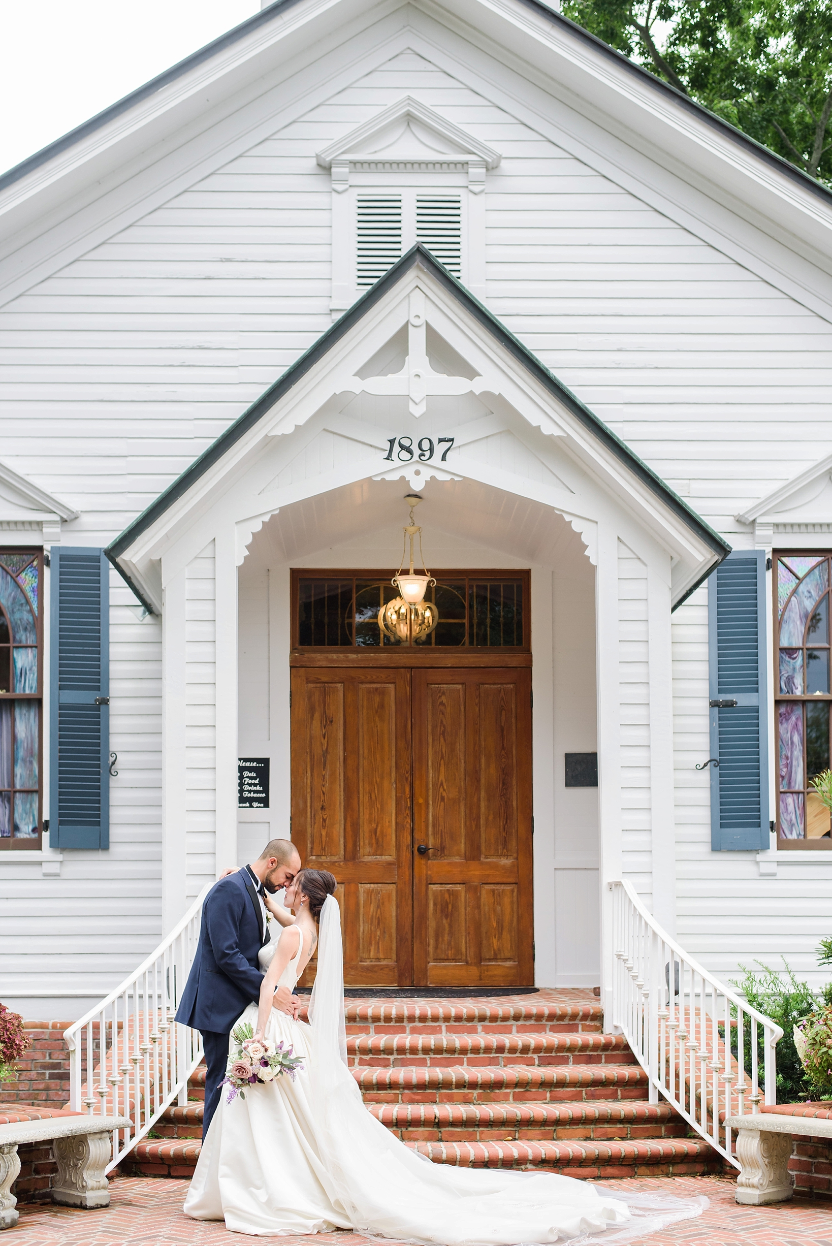 Bride and Groom share a quiet moment in front of their wedding chapel by Sarah & Ben Photography