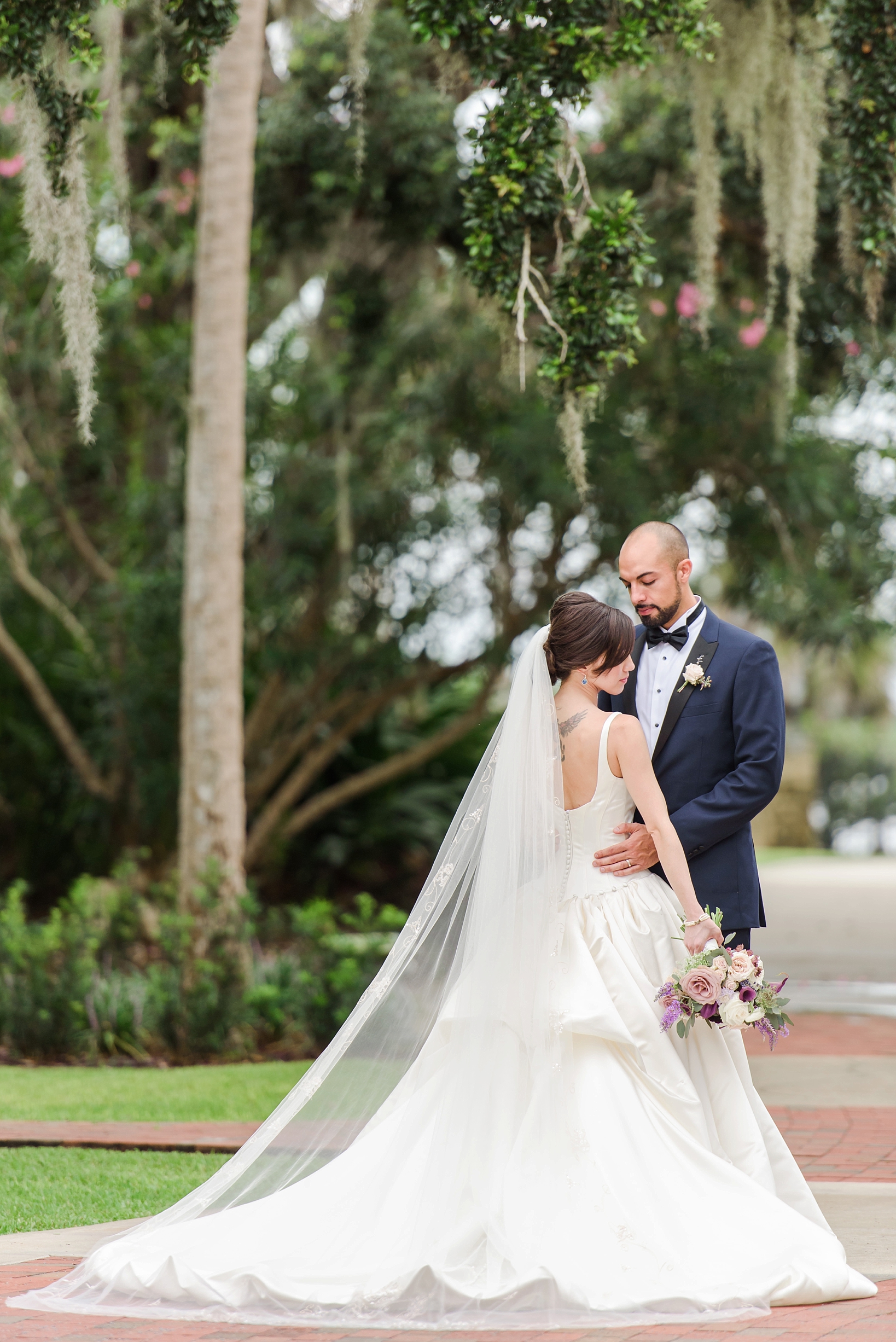 Bride and Groom in a dramatic pose in Port Orange, Fl by Sarah & Ben Photography