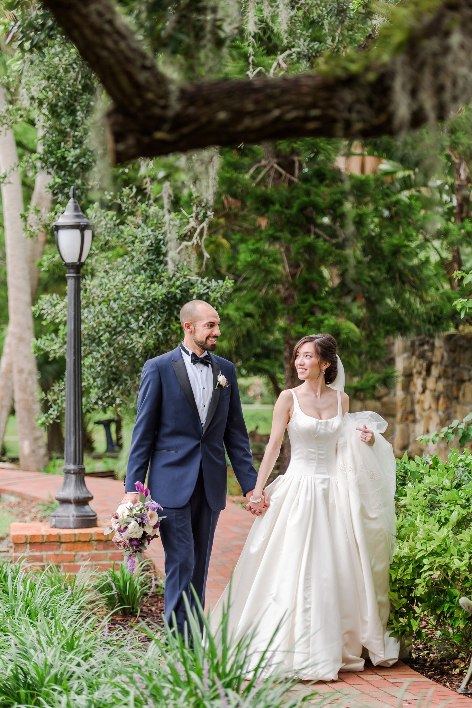 Bride and Groom stroll through the grounds of the Estate on the Halifax in Port Orange by Sarah & Ben Photography