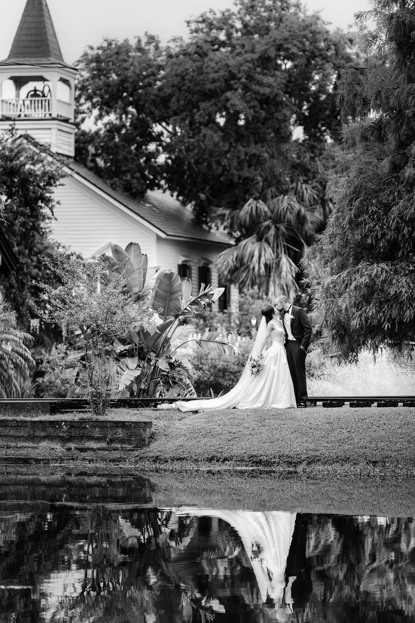 A beautiful image of the bride and groom reflecting in the ponds of the estate on the halifax by Sarah & Ben Photography