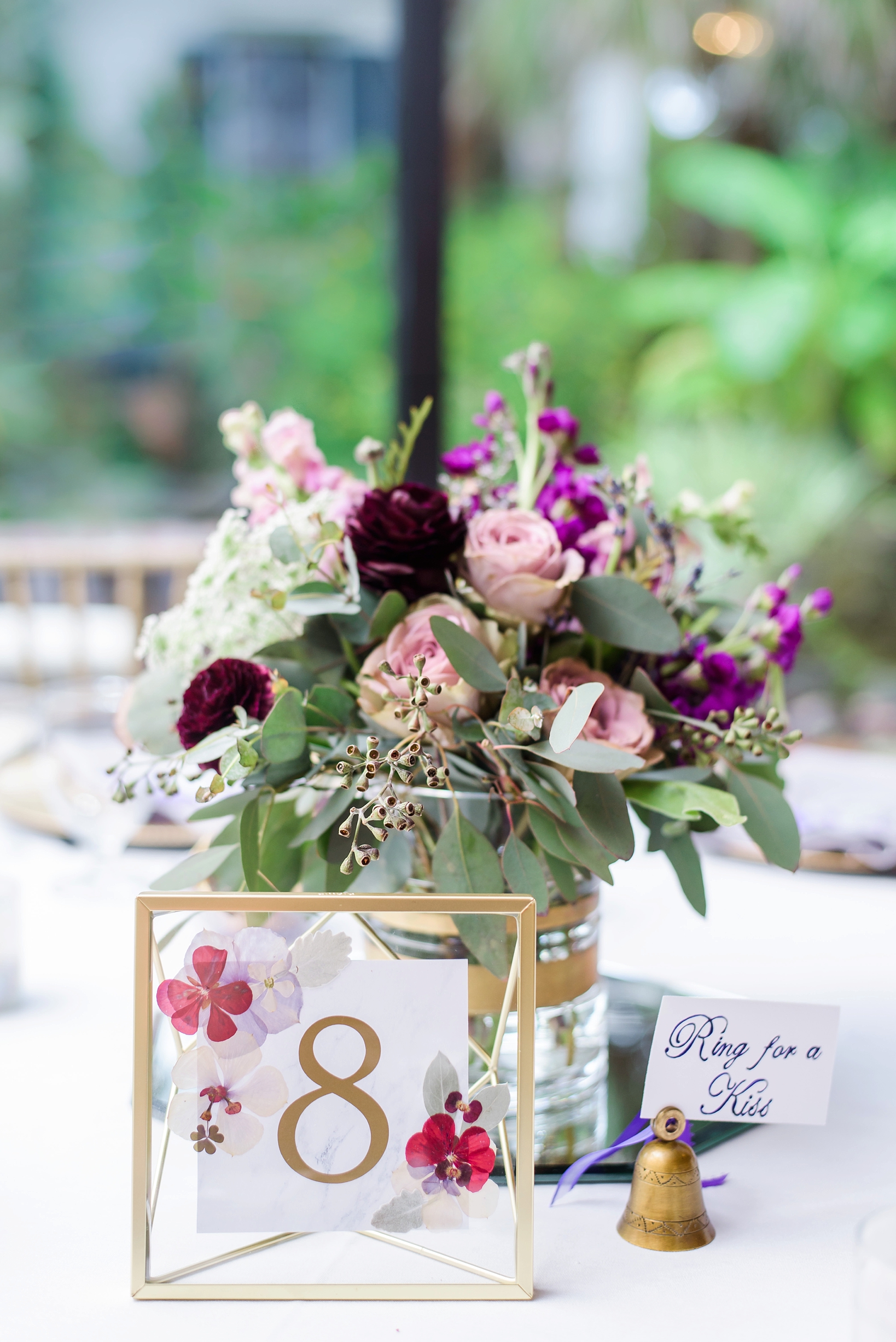 Table numbers with gold accents and beautiful floral centerpieces by Sarah & Ben Photography