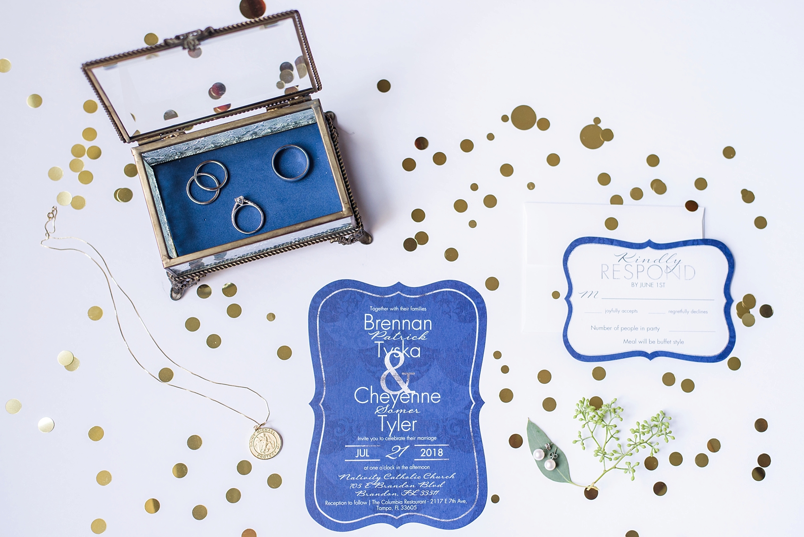 Lay Flat picture of the wedding invitation suite and the wedding rings