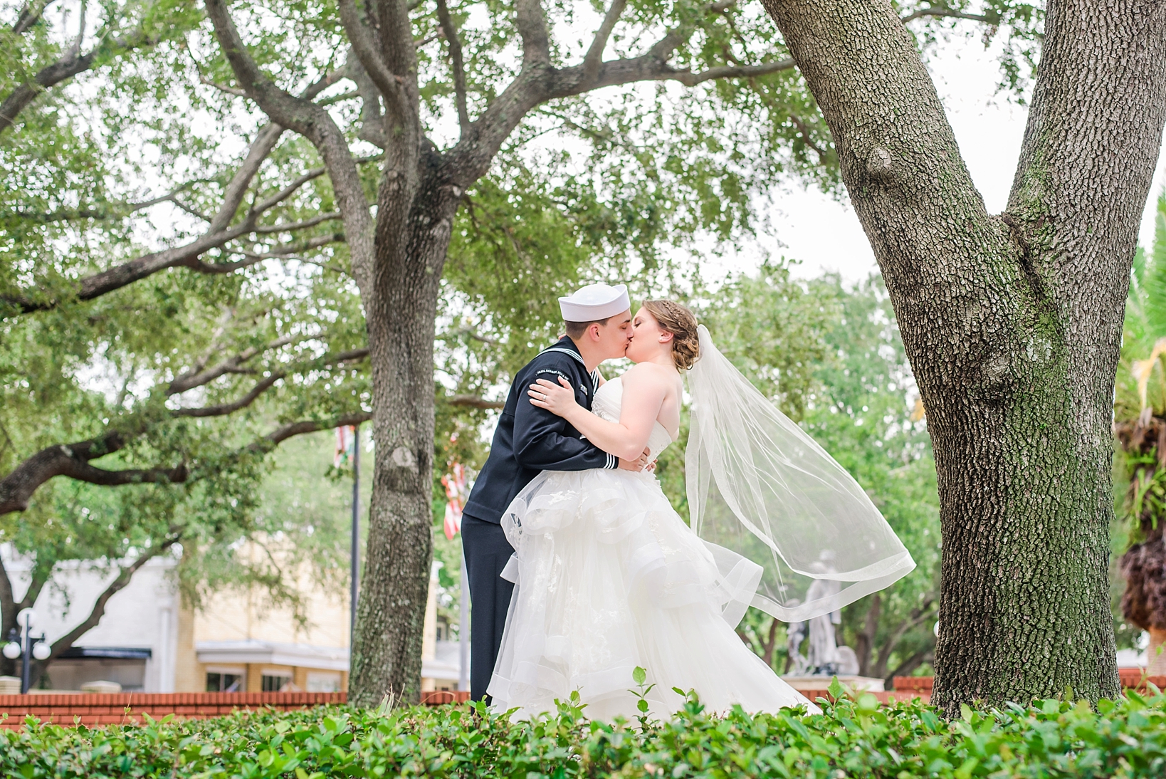 Bride and groom kissing under the old oak trees of Historic Ybor City