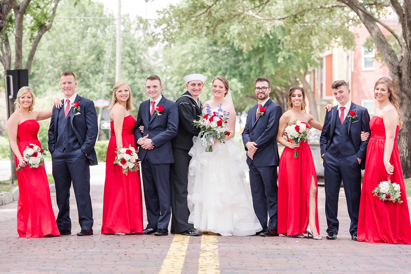 The wedding party on the brick streets of Ybor City in their red dresses and navy suits