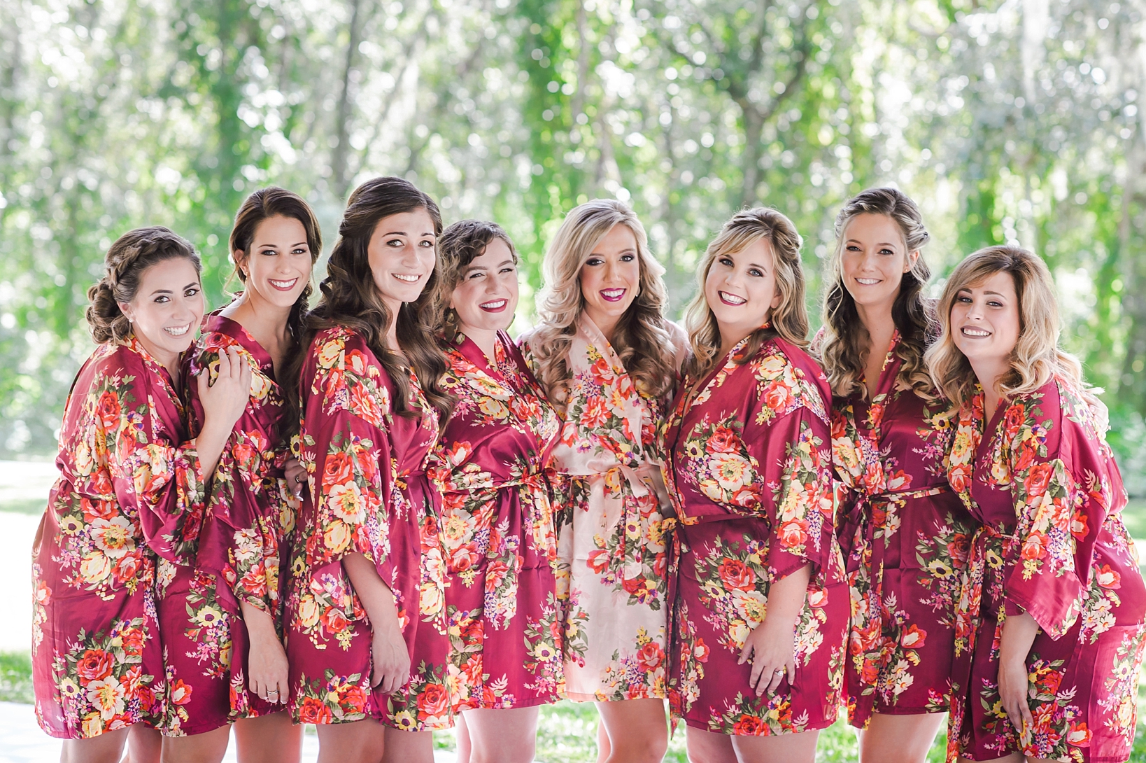 The Bride and her Bridesmaids all wear matching floral robes by Sarah & Ben Photography 