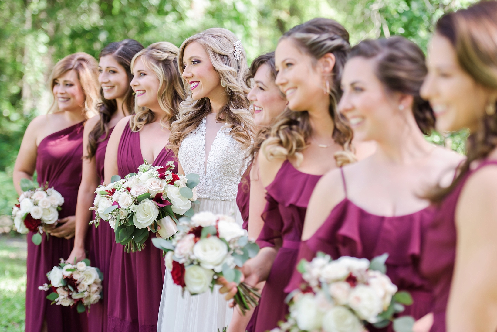 Bride and her bridesmaids in merlot dresses