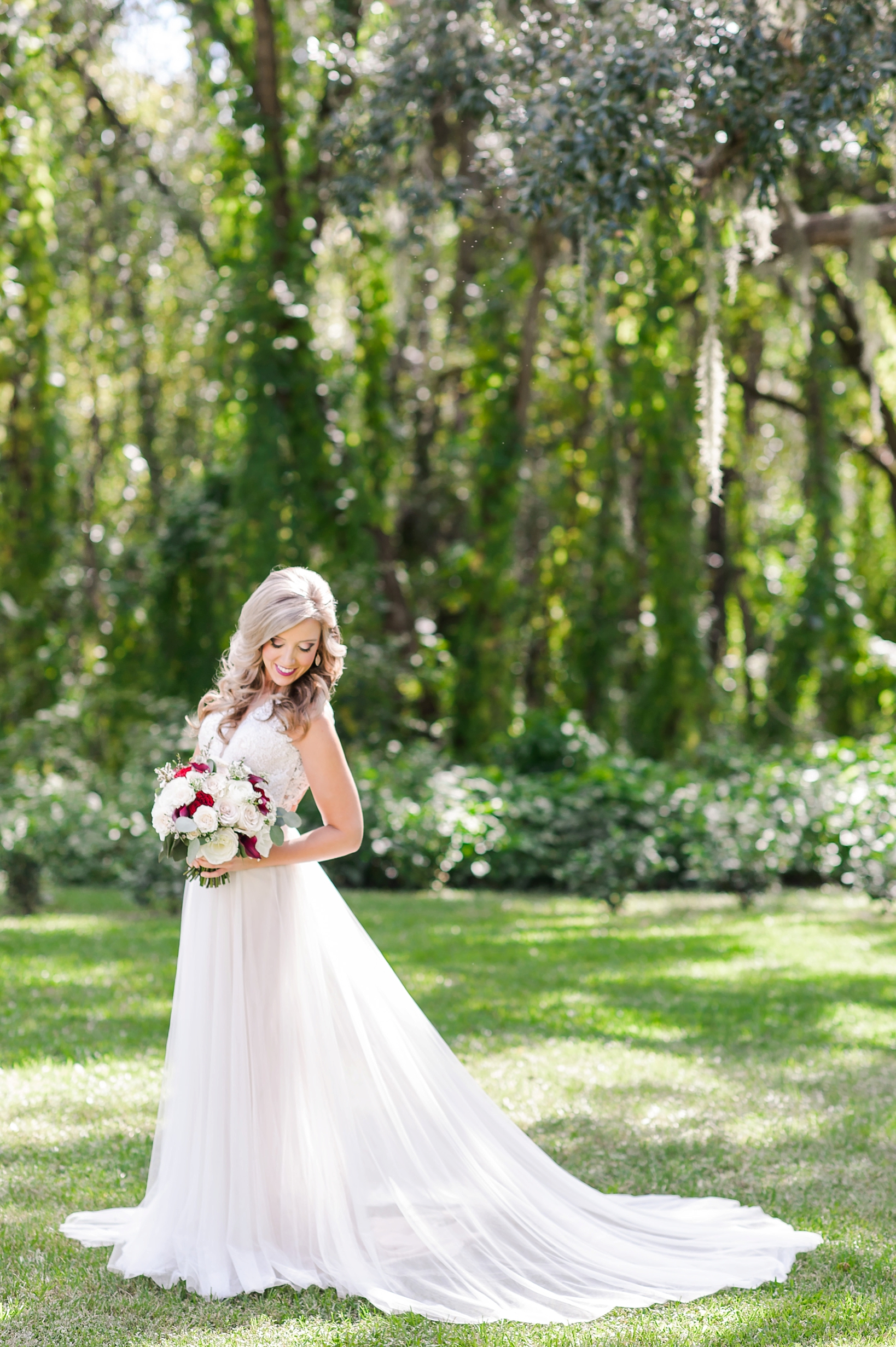 Beautiful wedding photo of the bride dappled in sunlight by Sarah & Ben Photography 