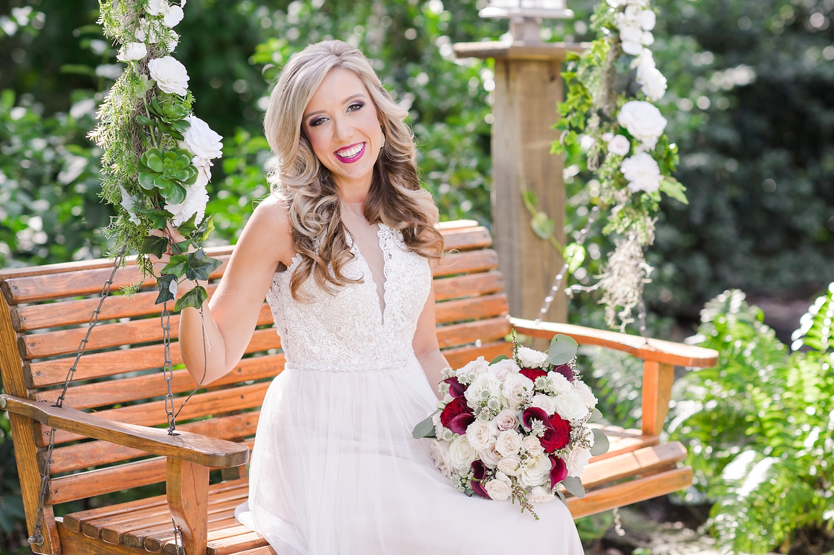 Amazing portrait of a Bride on her wedding day sitting on a bench swing by Sarah & Ben Photography 