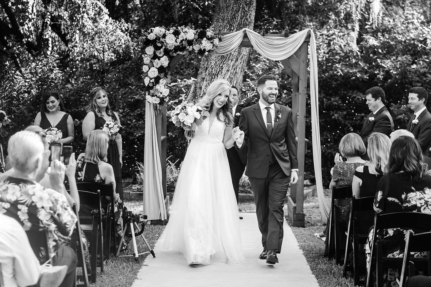 The bride and groom walk back up the aisle as husband and wife for the very first time by Sarah and Ben Photography
