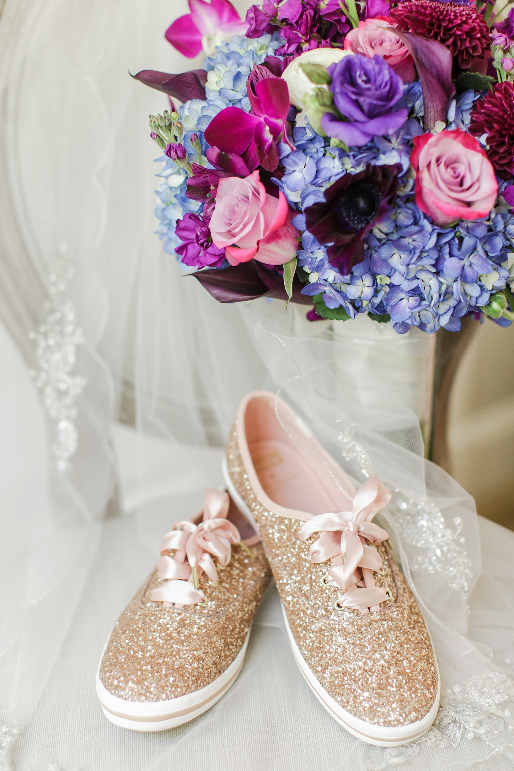 Kate Spade rose gold sneakers with the bride's floral bouquet by Sarah & Ben Photography