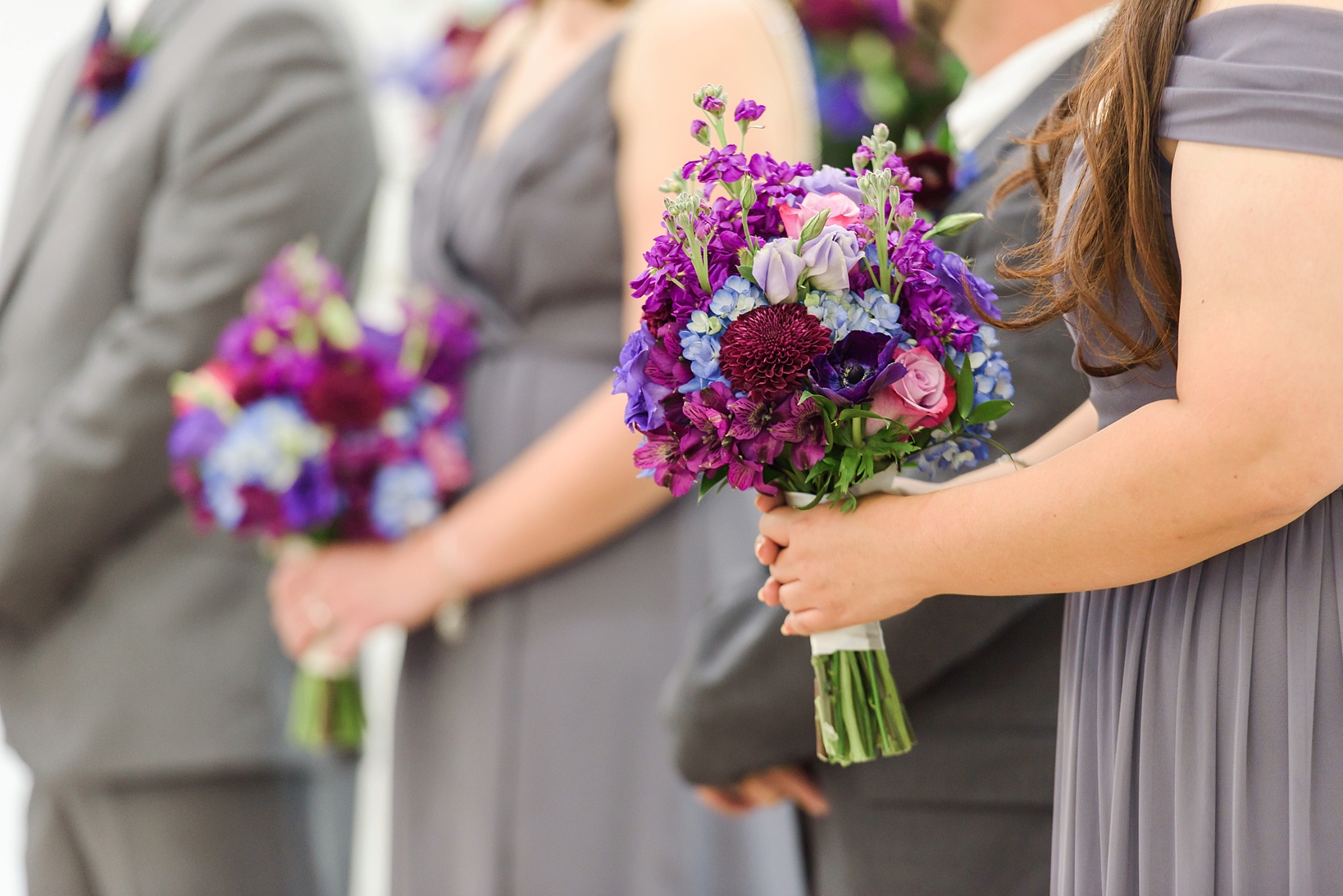 Bridesmaids florals being held by a bridesmaid