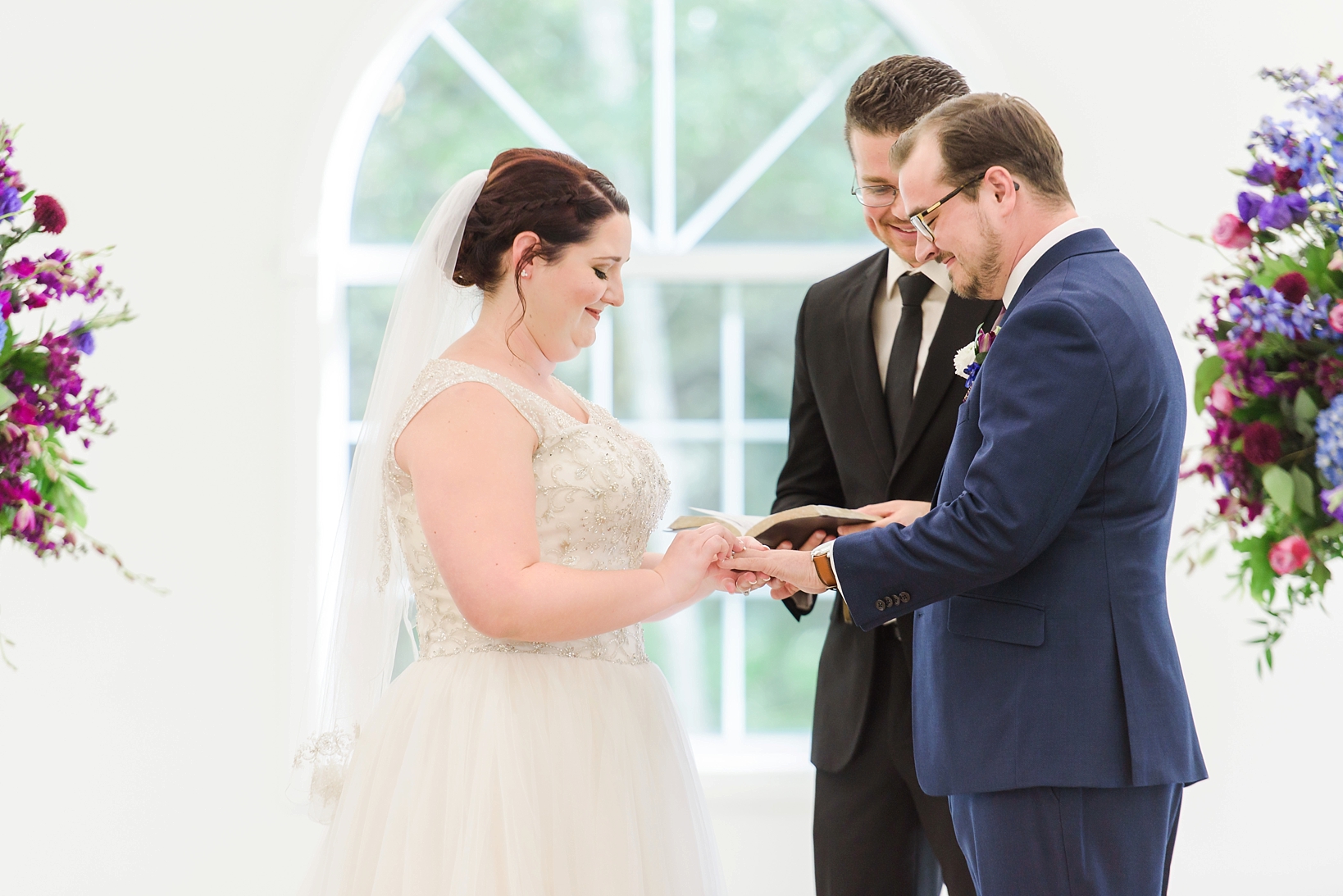 Exchanging rings during the ceremony by Sarah & Ben Photography