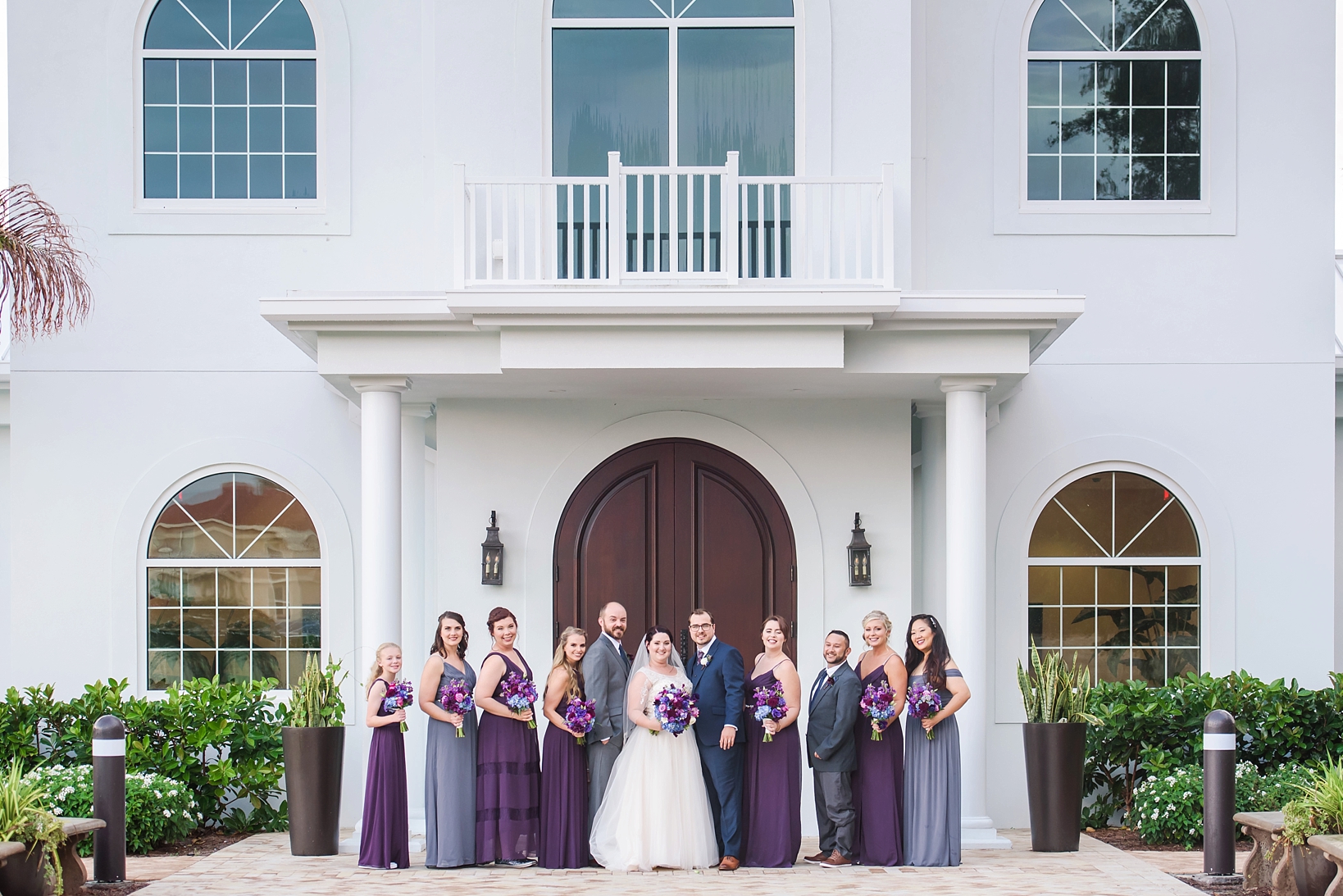 The bridal party pose outside the chapel by Sarah & Ben Photography