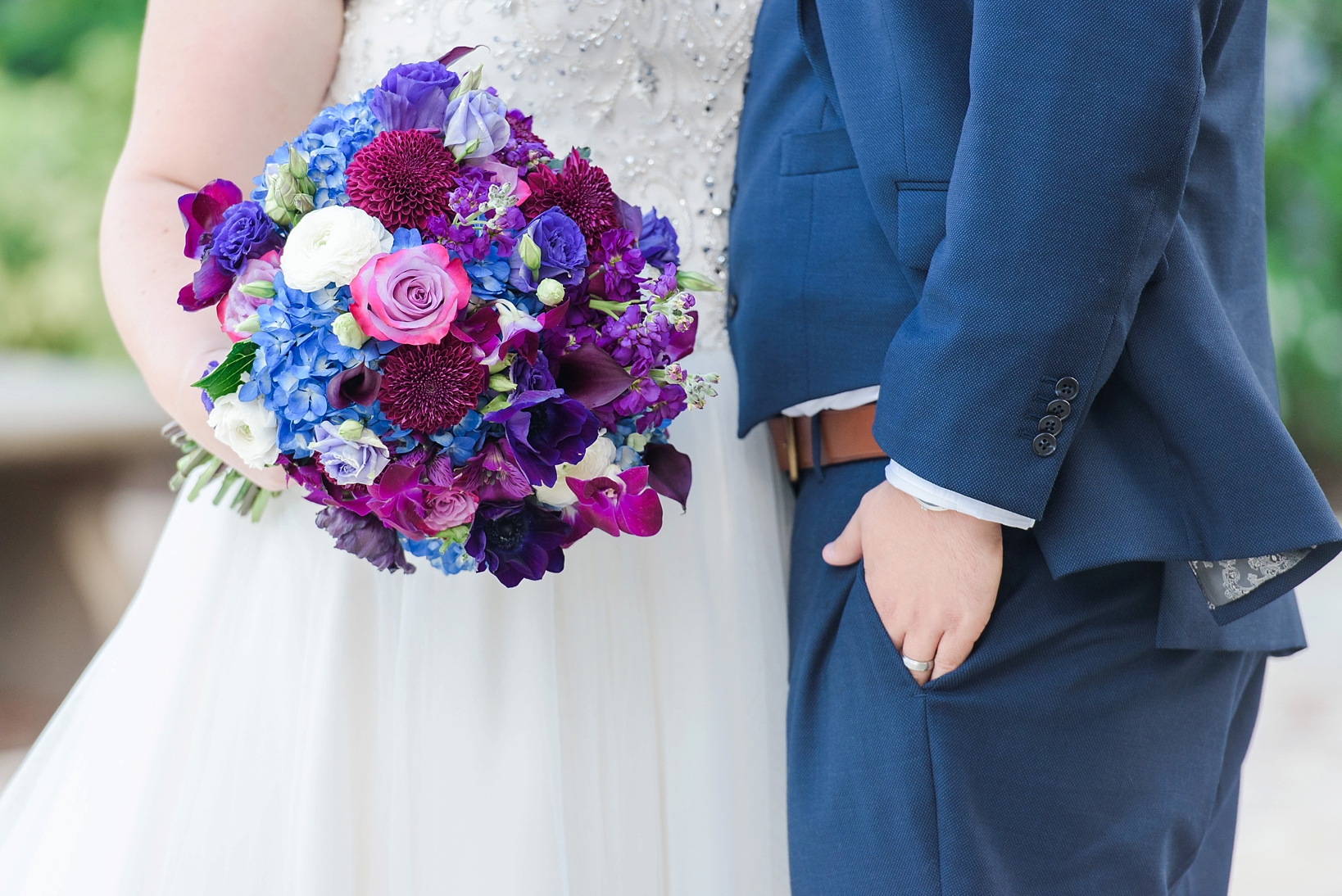 Floral bouquet of the bride featuring deep purples and blues by Sarah & Ben Photography