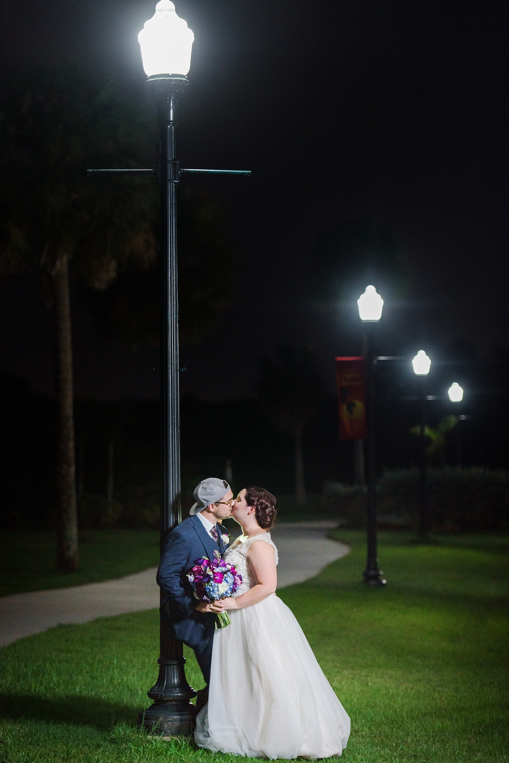 Bride and Groom slipped outside for some night photography by the street lamps by Sarah & Ben Photography
