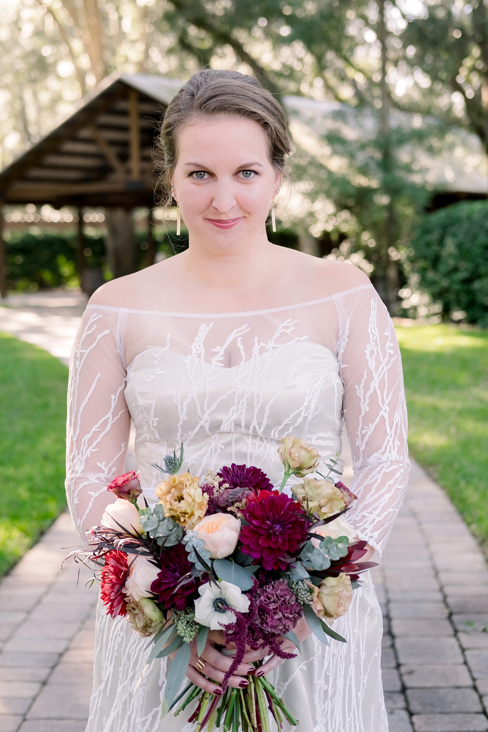 Waist up shot of the Bride holding her flowers as she looks into the camera
