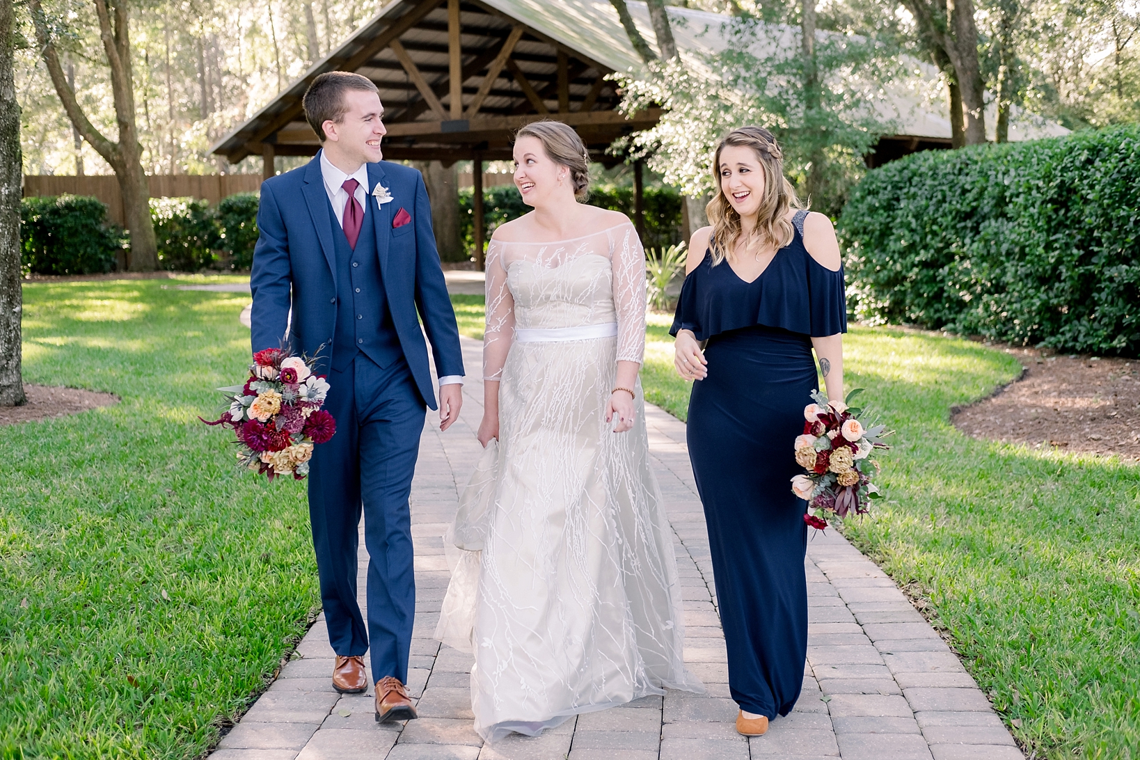 Bride and her wedding party walk a brick path at Bowing Oaks Plantation in Jacksonville, FL