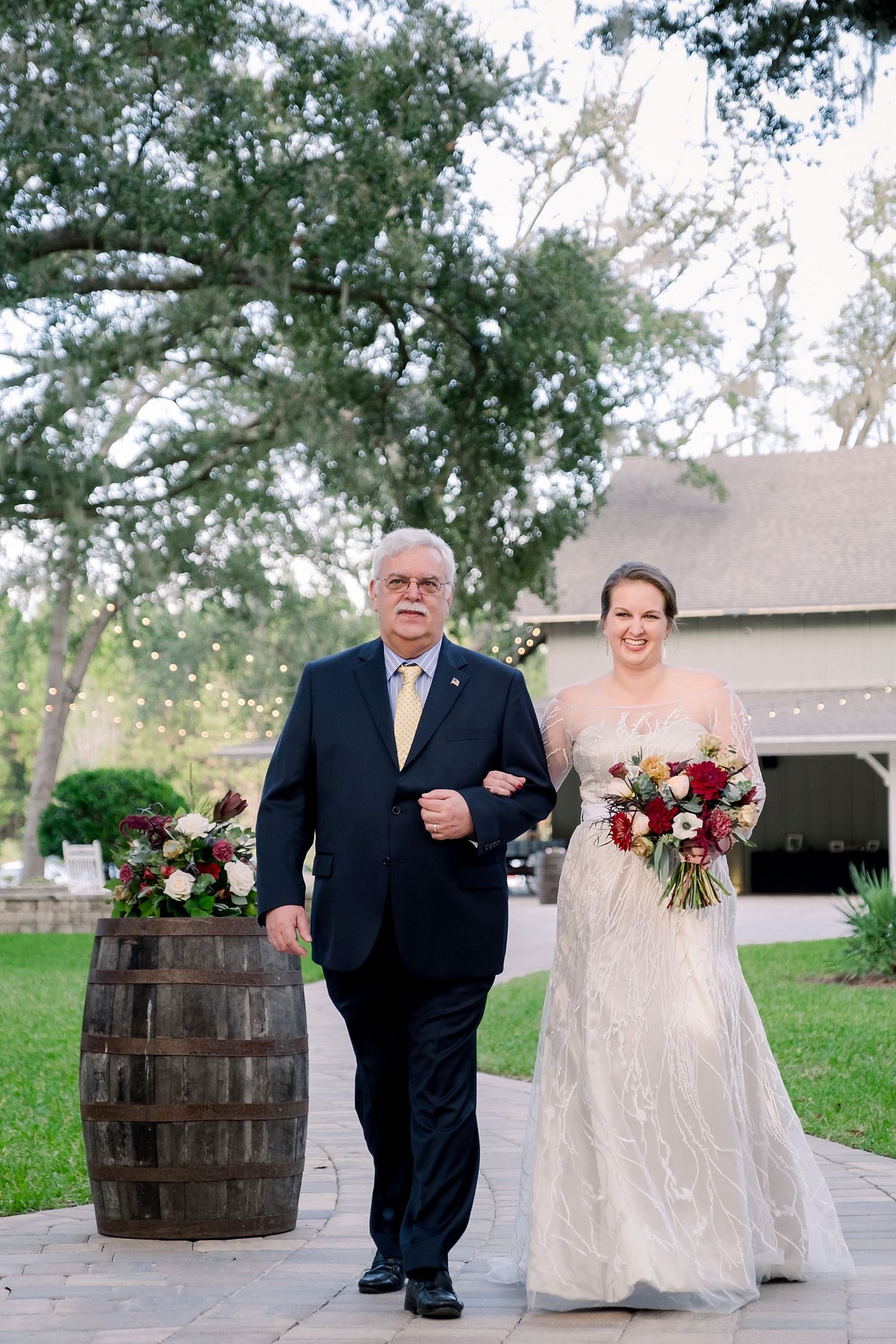 The bride and her father walk down the aisle at Bowing Oaks Plantation