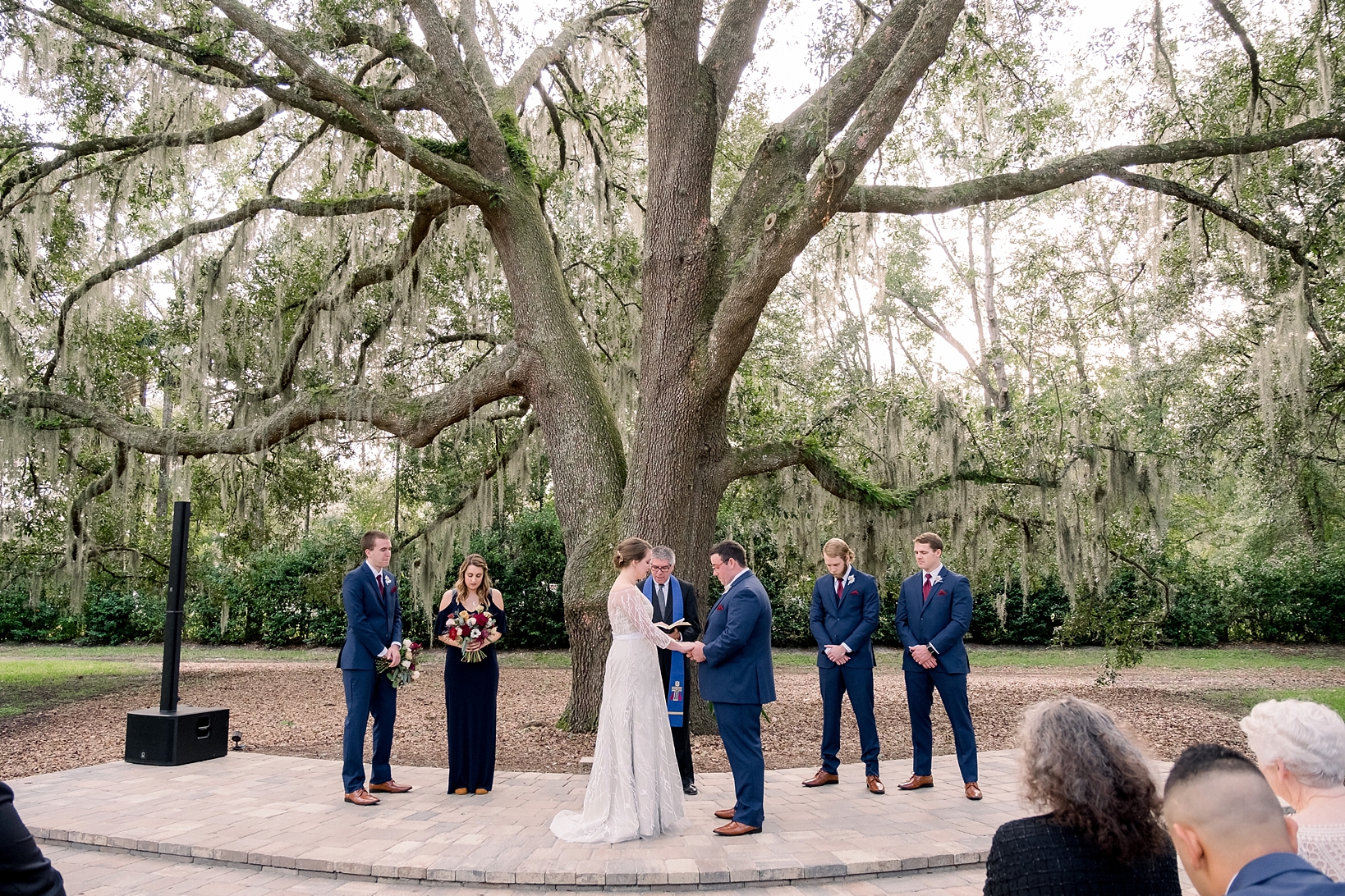 The wedding ceremony under an oak tree by Sarah & Ben Photography