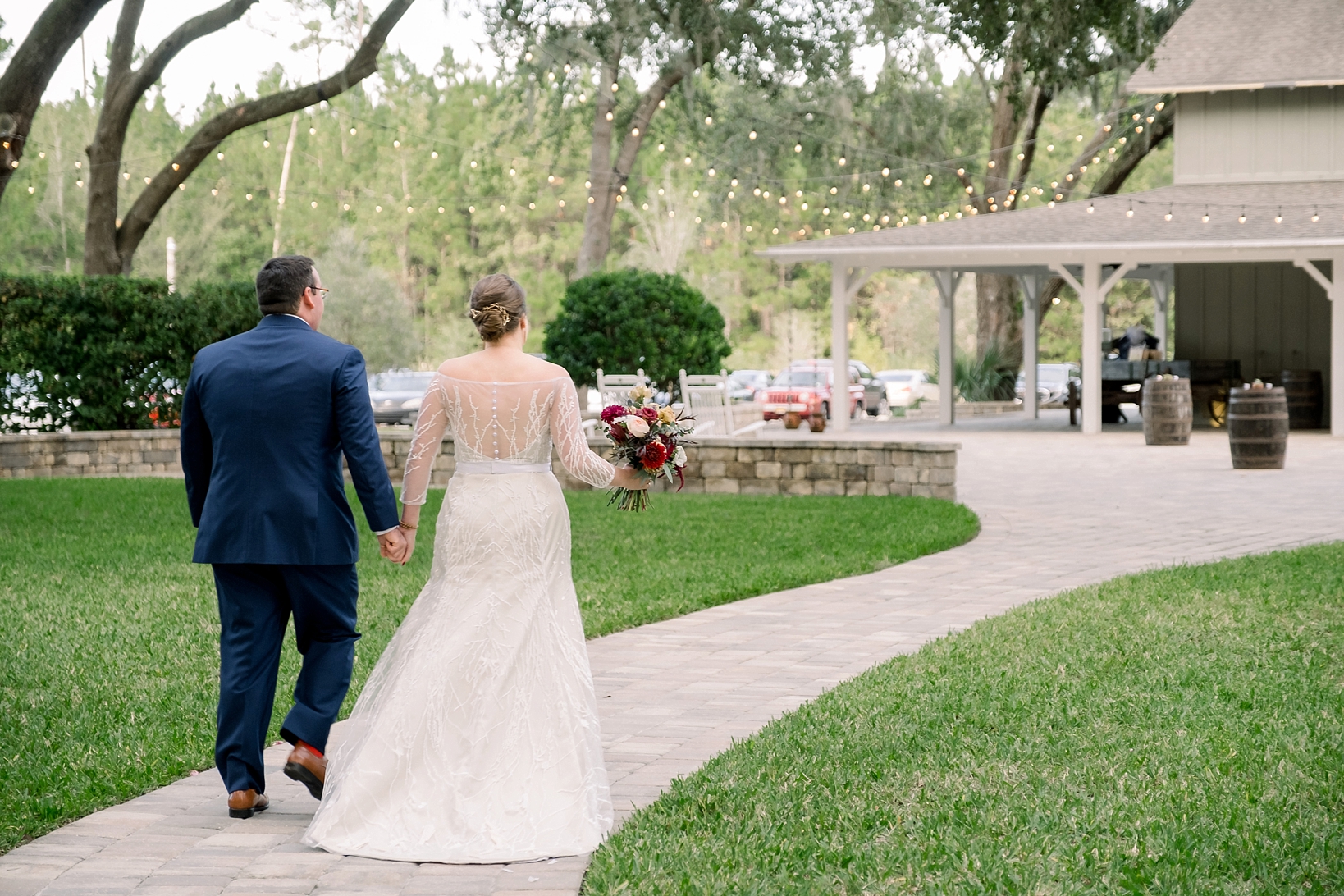 Bride and Groom walk back up the aisle to their wedding reception at Bowing Oaks Plantation