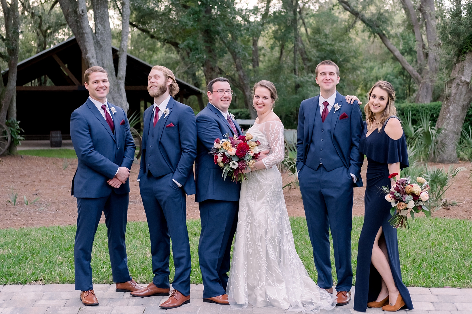 The wedding party pose along a brick path at Bowing Oaks Plantation in Jacksonville, FL
