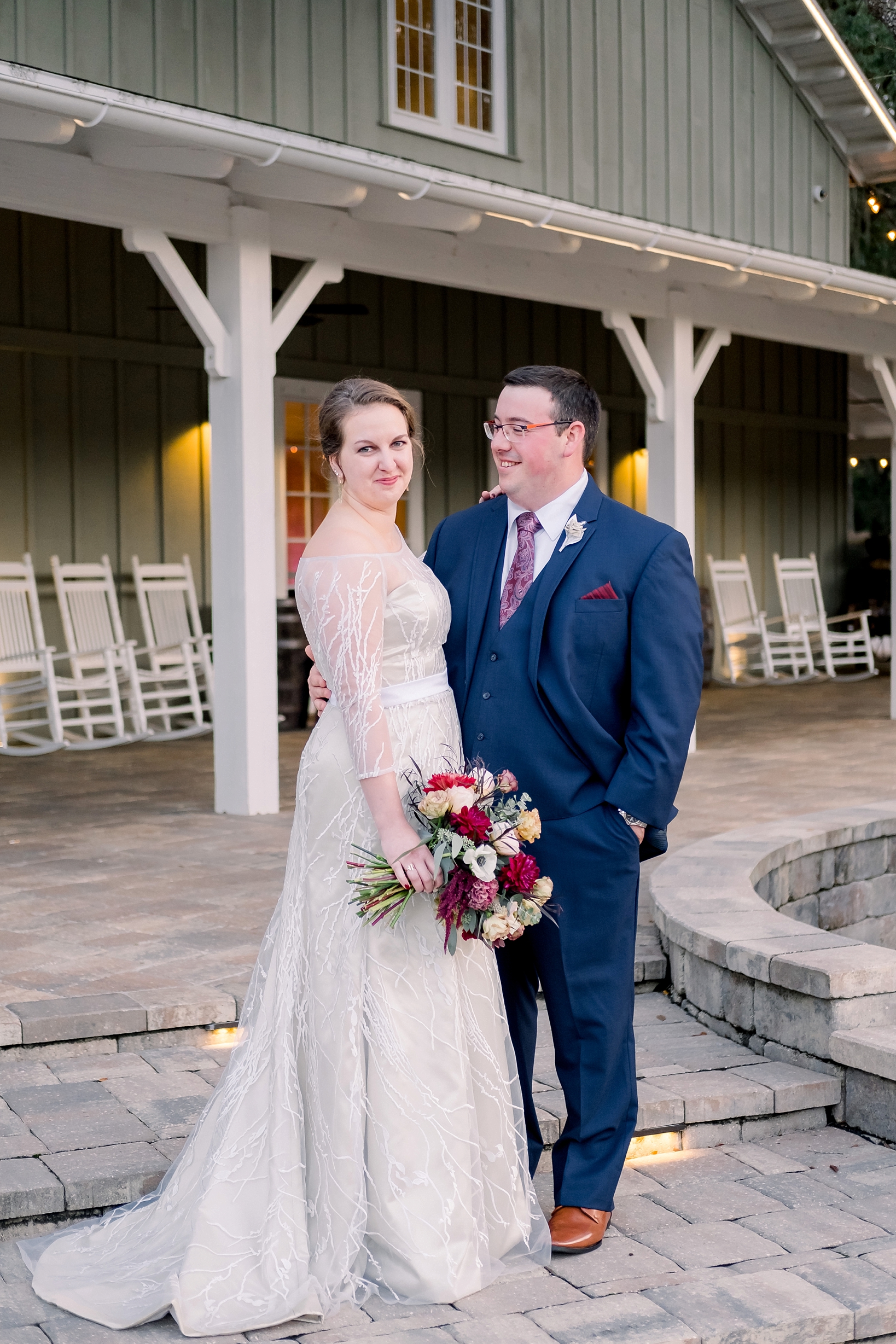 The newlyweds pose in front of the reception barn at the Bowing Oaks Plantation