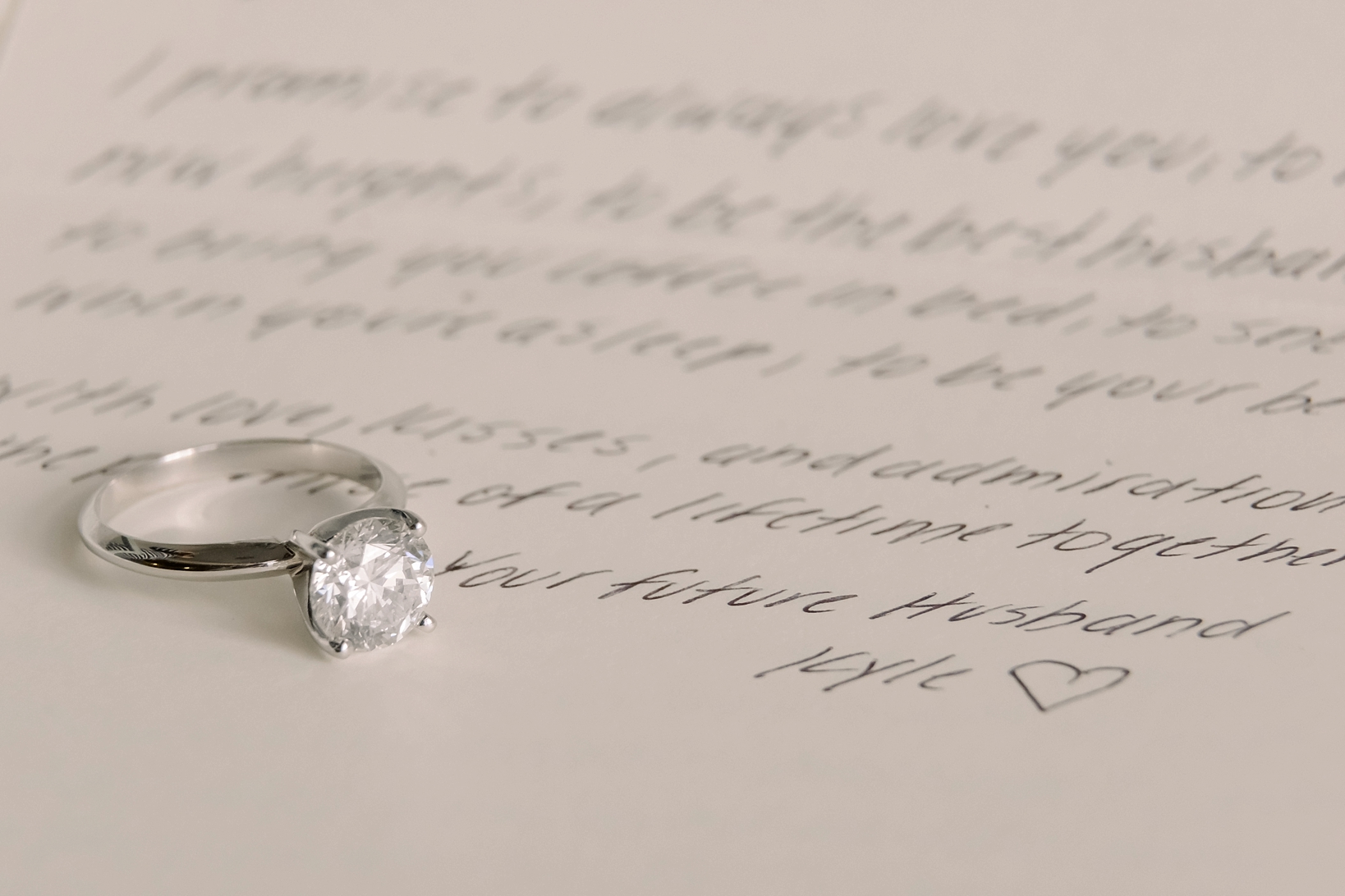 The bride's engagement ring on her fiance's letter to her on their wedding day