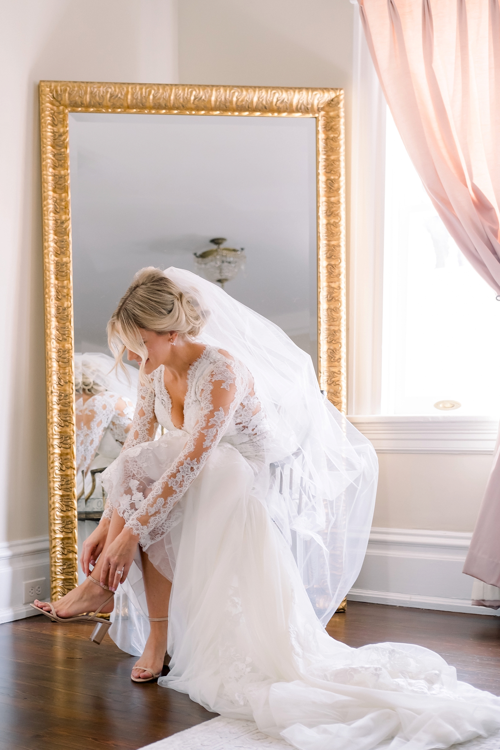 The bride getting into her heels in her bridal suite
