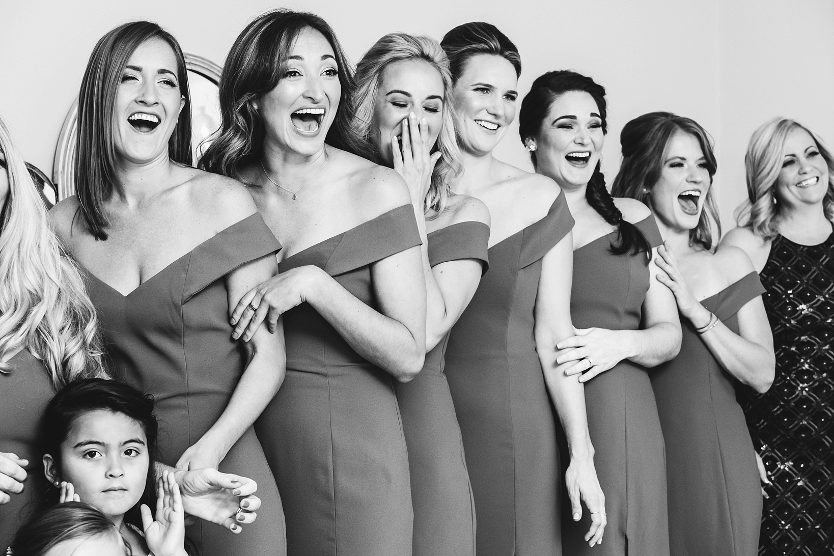 Bridesmaids react to seeing the bride for the first time in black and white by Sarah & Ben Photography