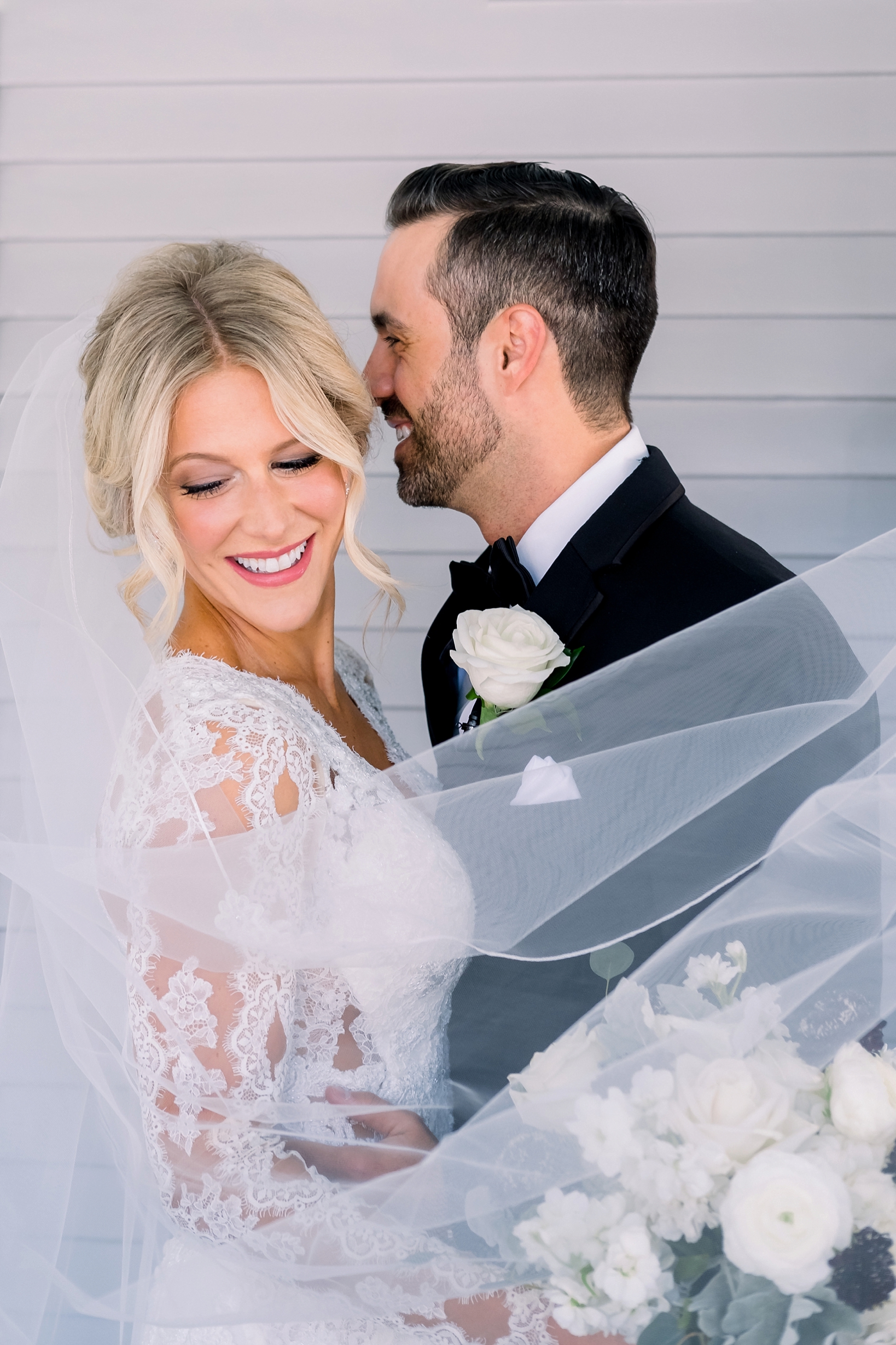 Groom whispers into his bride's ear during their first look by Sarah & Ben Photography
