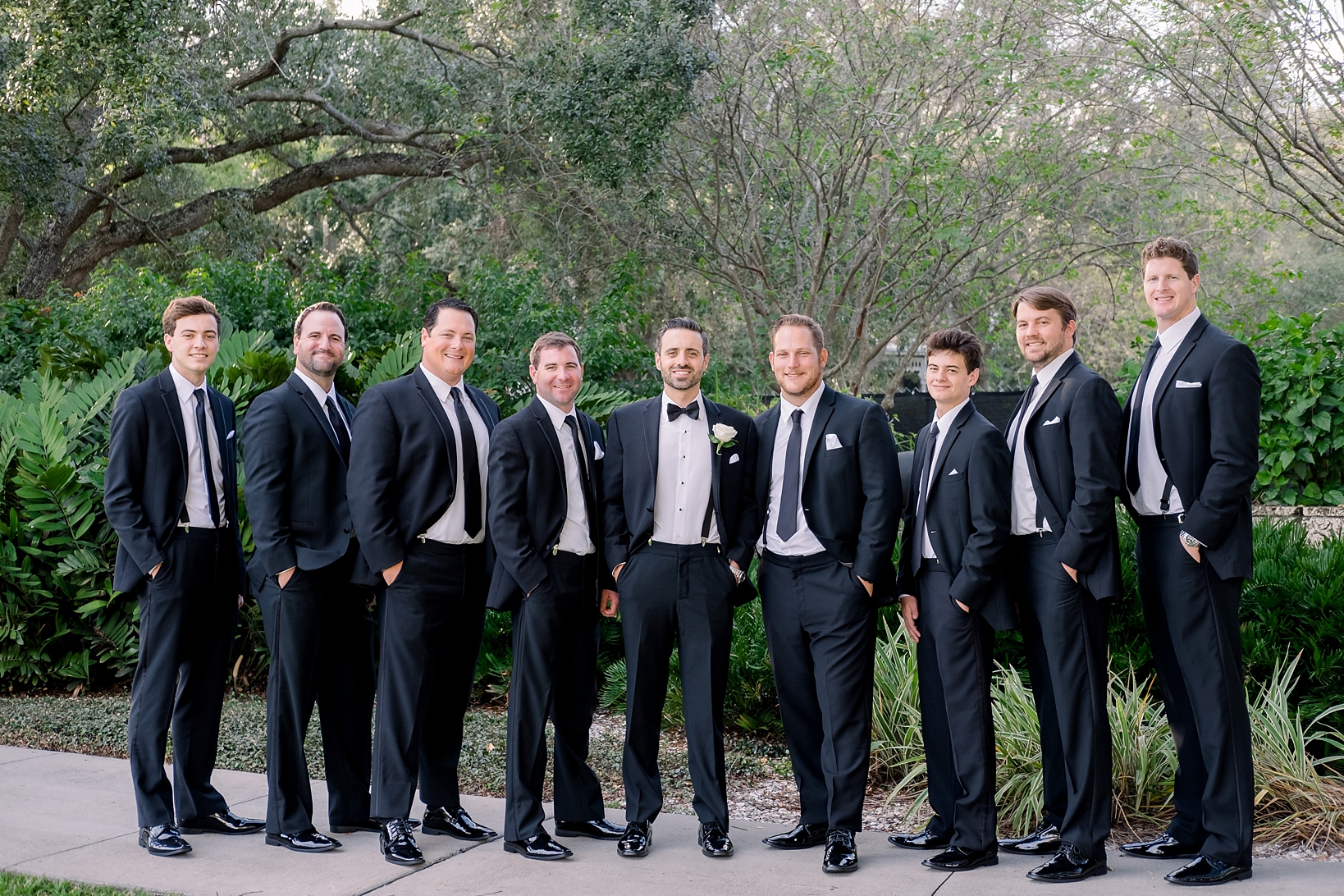 The Groom and his Groomsmen in classic black and white tuxedos by Sarah & Ben Photography