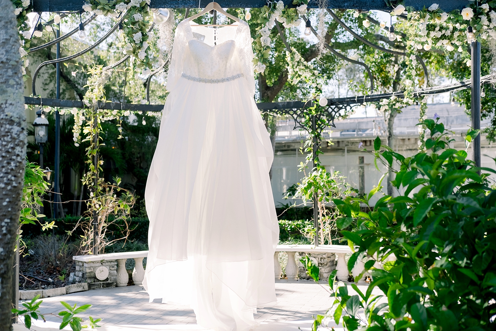 The bride's dress hanging against the greenery of the Kapok Tree by sarahben.com