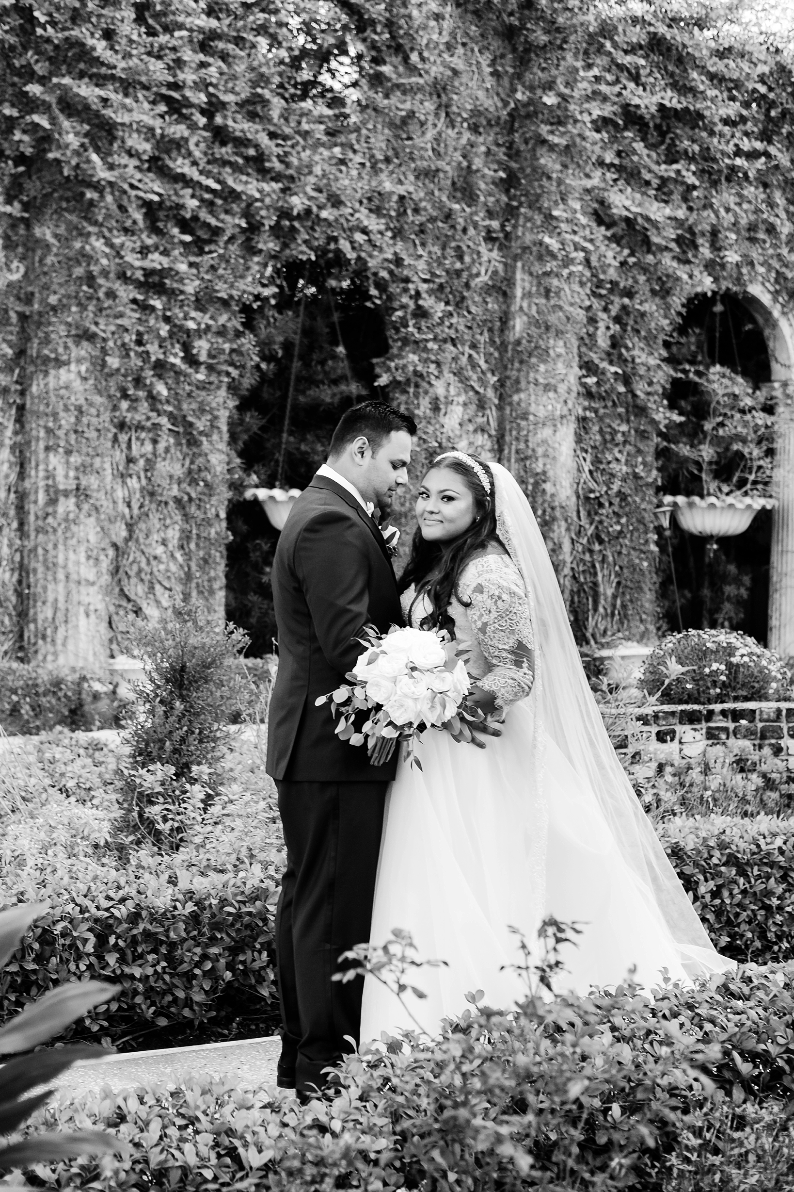 Timeless black and white photo of the bride and groom in the gardens of the Kapok Tree by sarahben.com