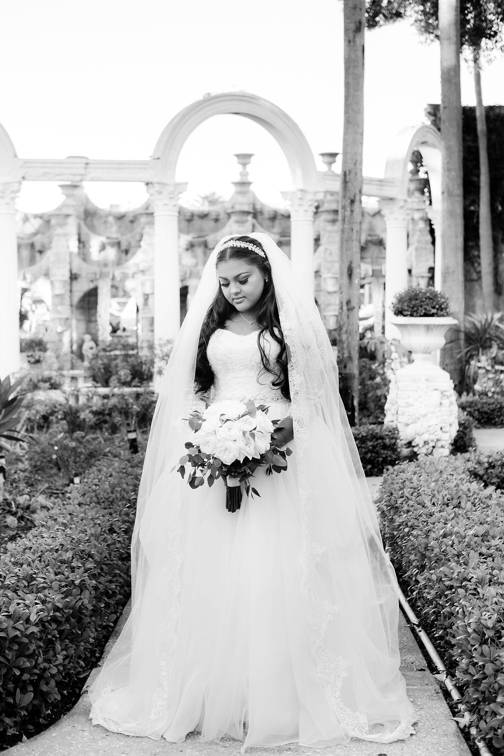 A timeless portrait of the bride in black and white at the Kapok Tree in Clearwater, FL. by sarahben.com