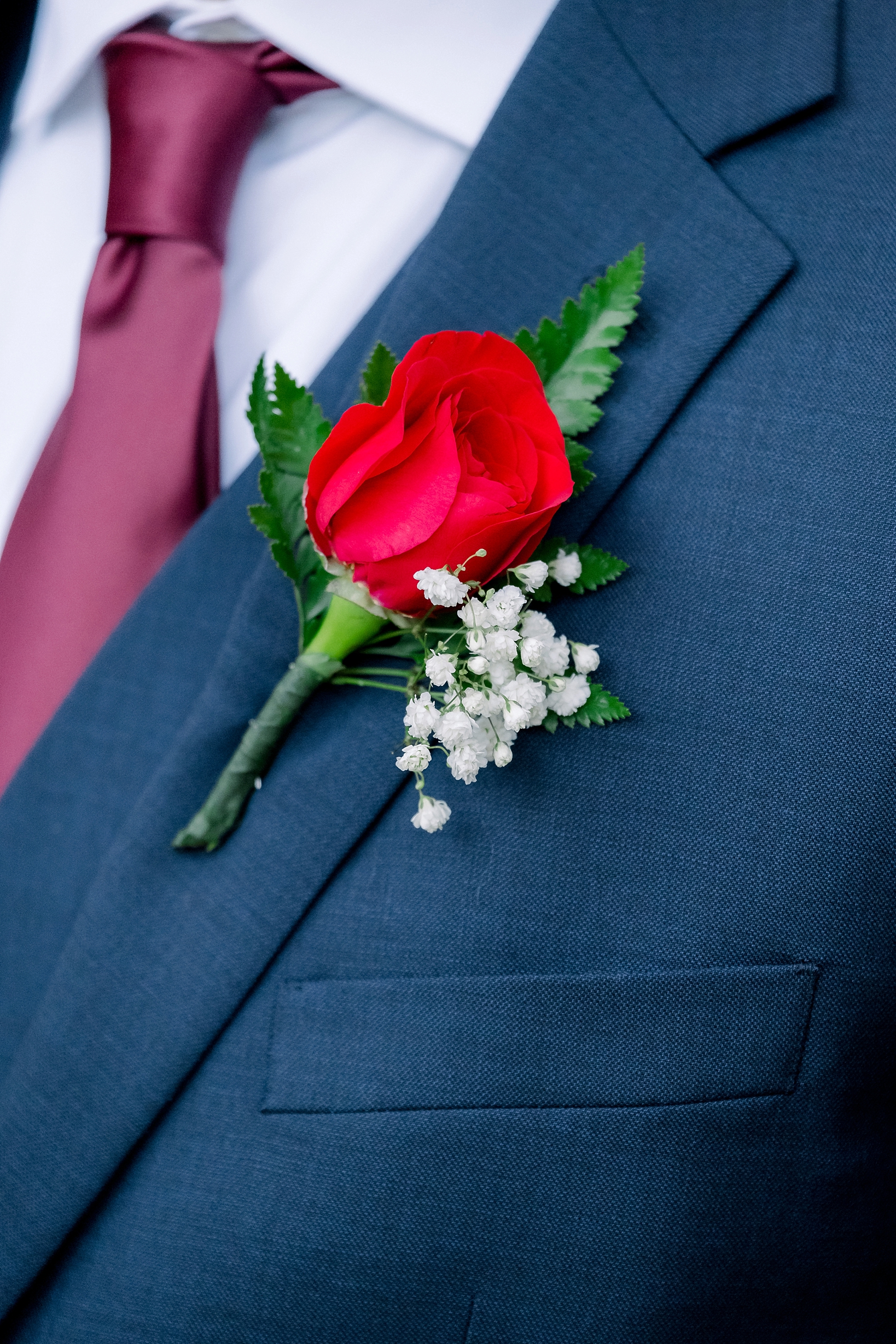 The red rose of the Groom's boutonniere by sarahben.com